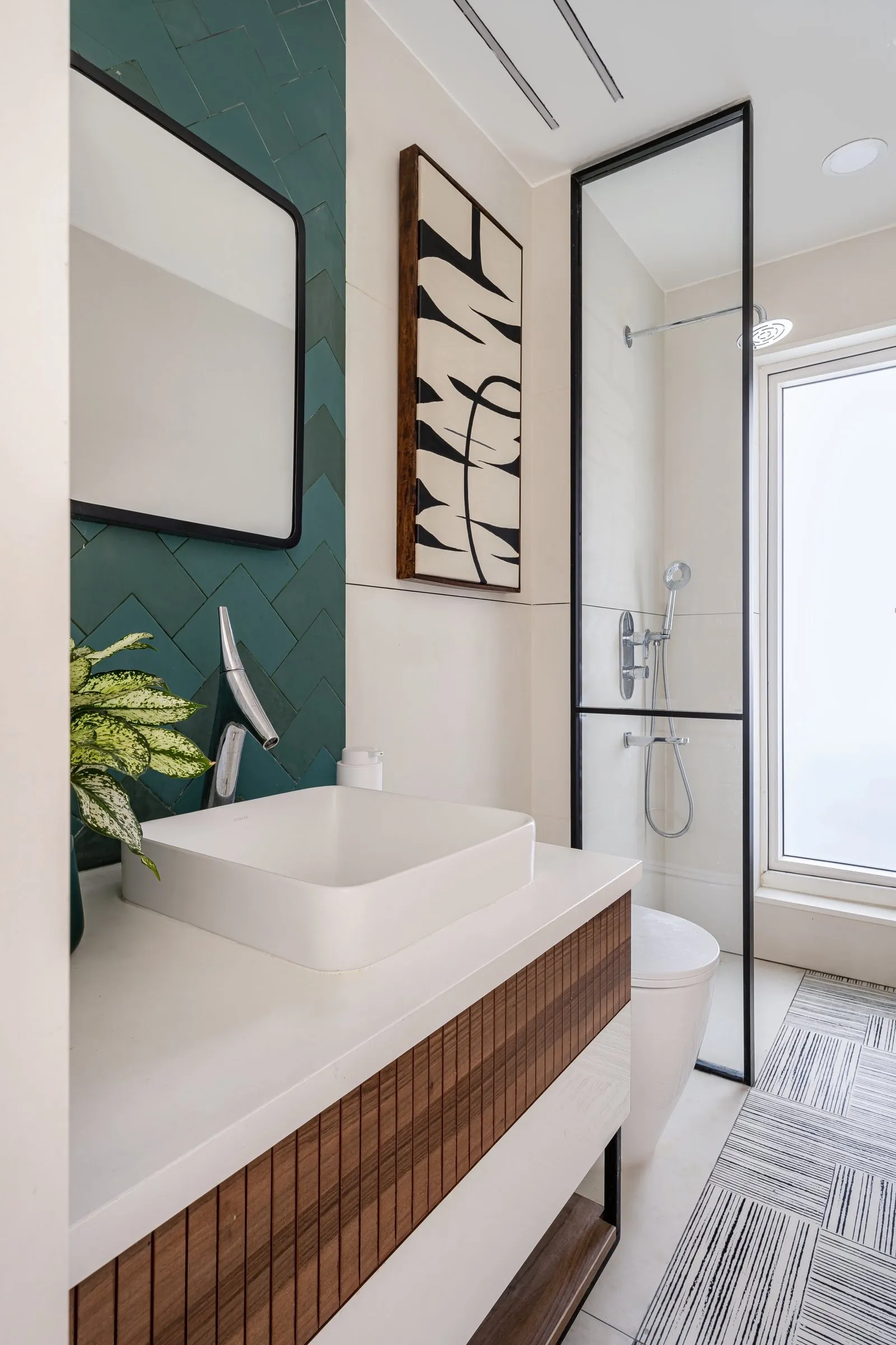 Bathroom with a teal tiled wall