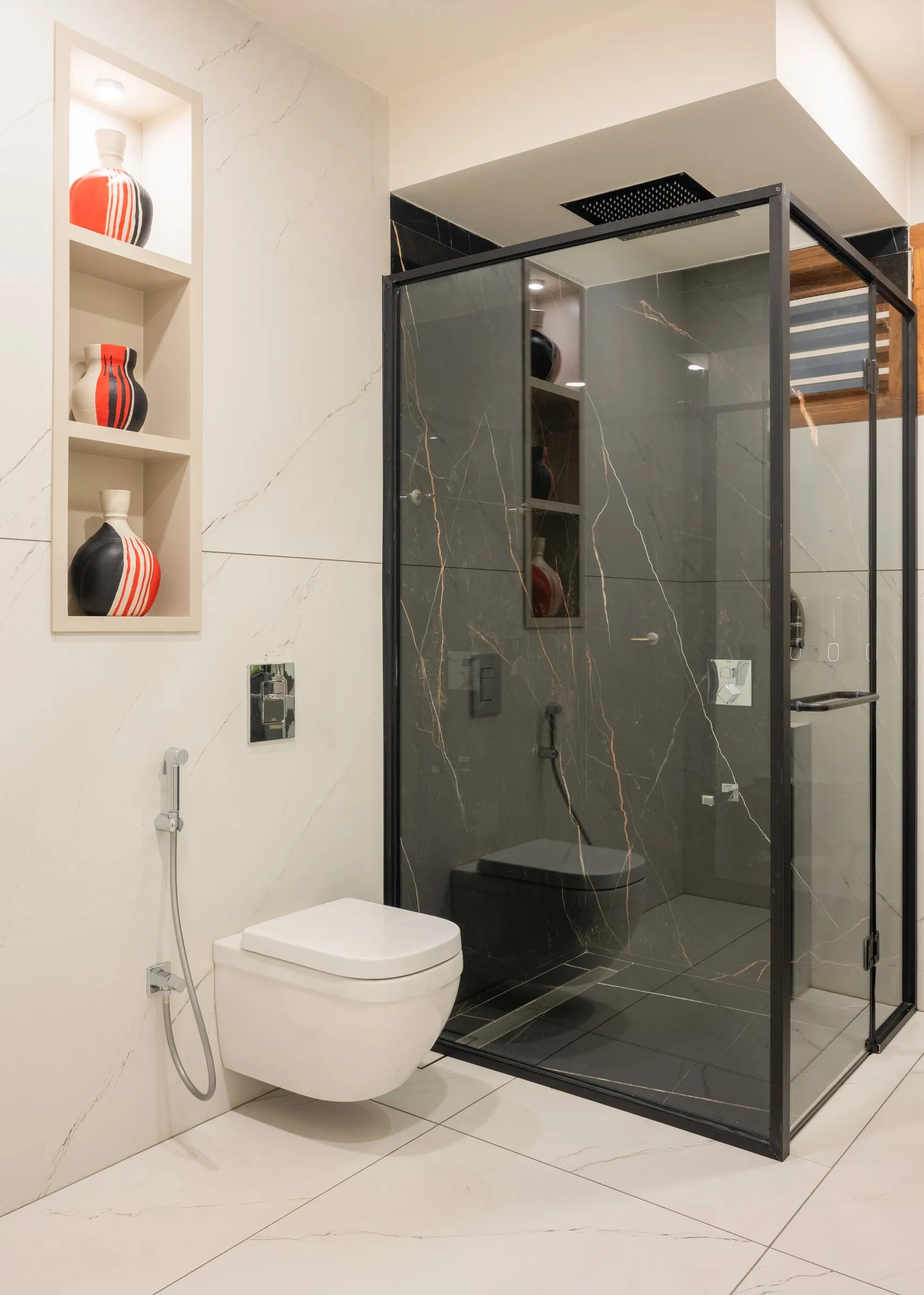 Bathroom with a smoked glass shower and red vase niche