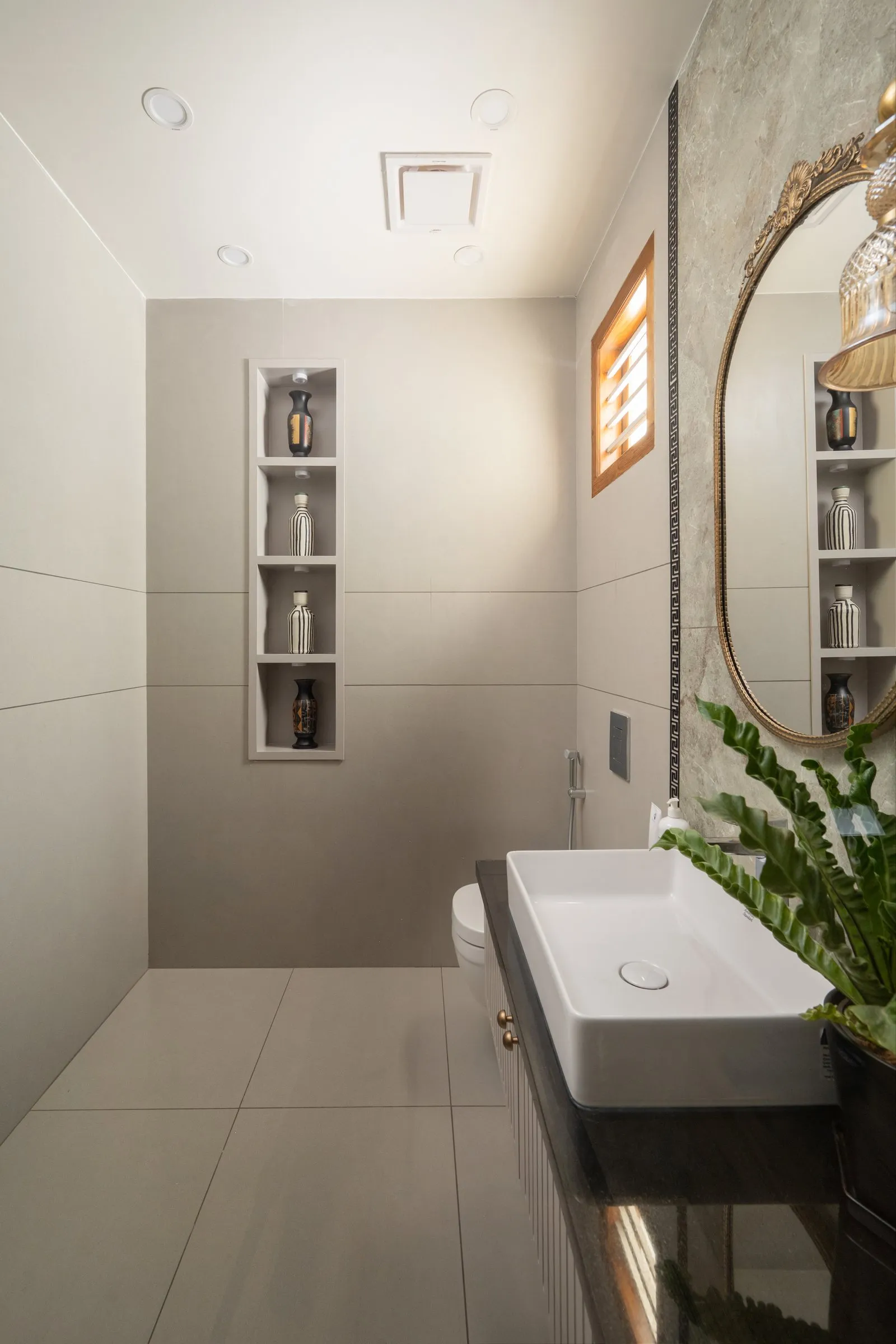 Bathroom with a long white basin and a wall niche