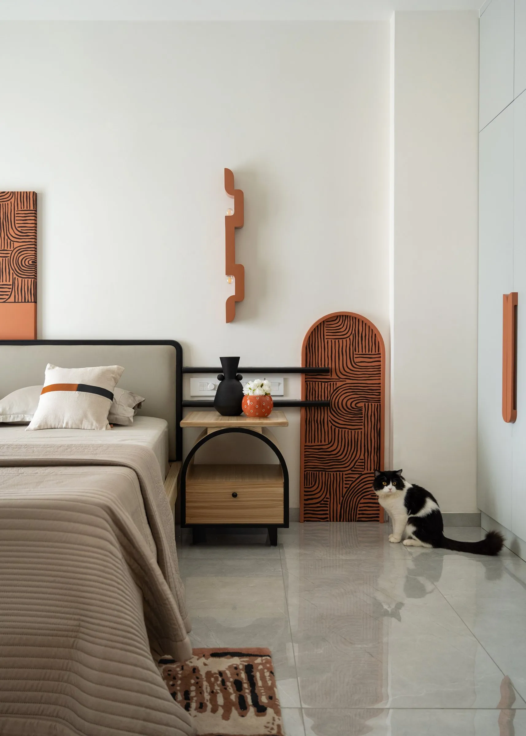 Bedroom with an arched door and the family cat