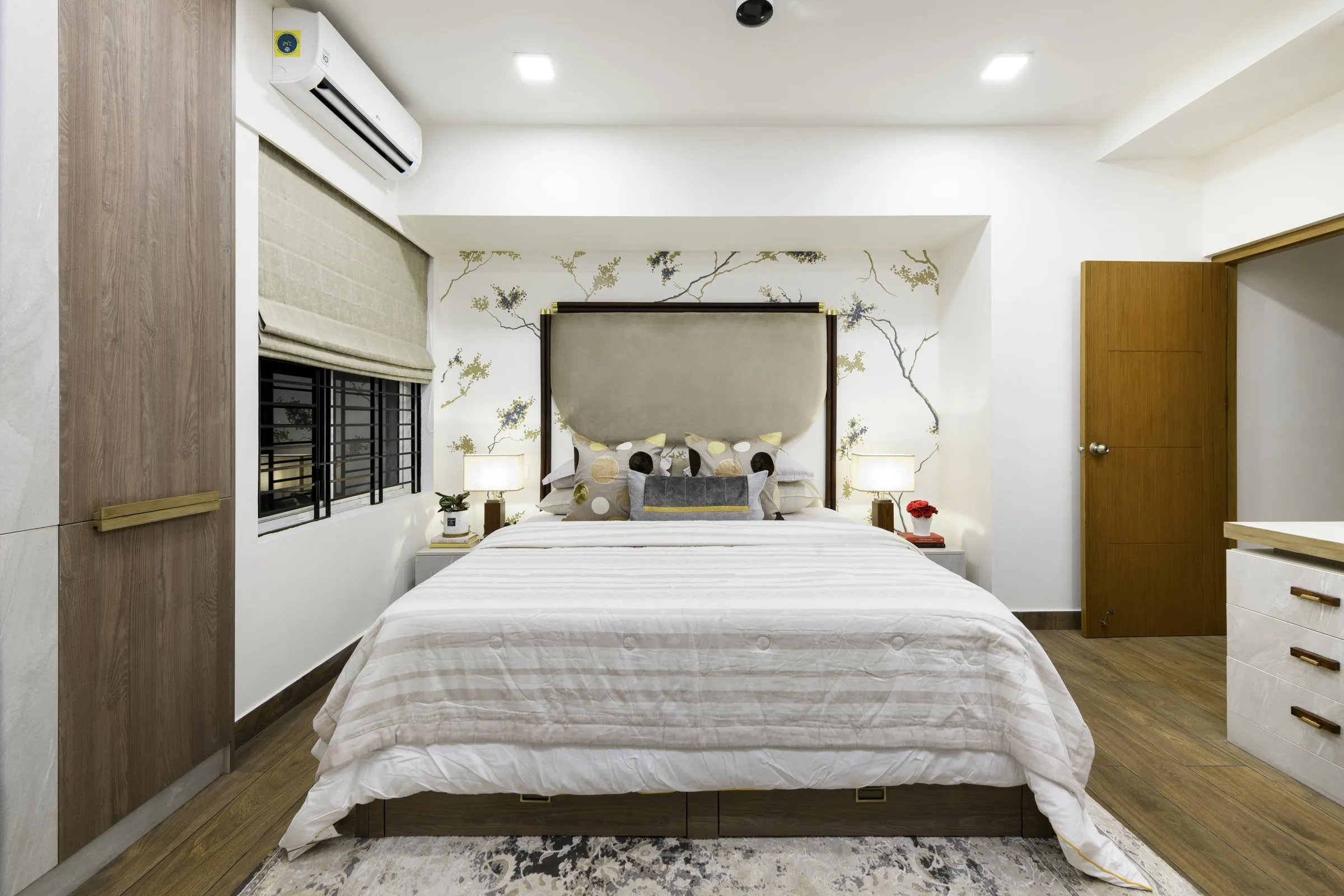 Bedroom with a painted blossom wall and a grey headboard