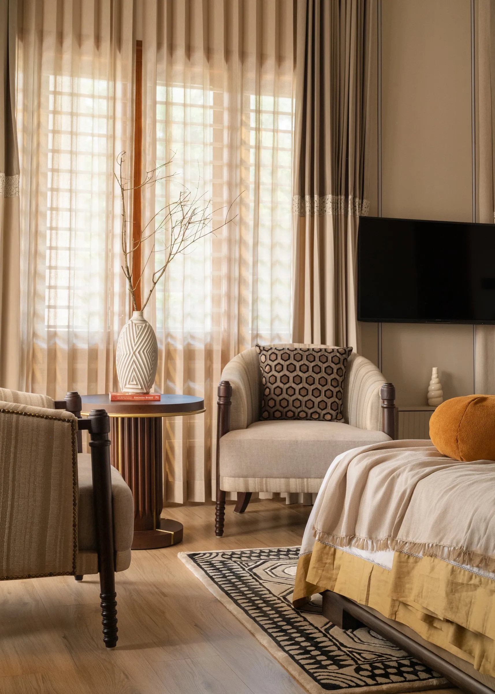 Bedroom seating corner by tall louvred windows