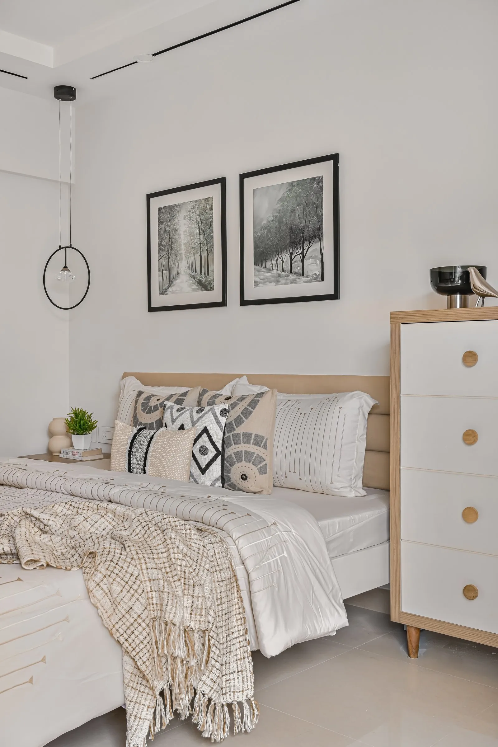 Bedroom with black and white forest prints and an oak chest