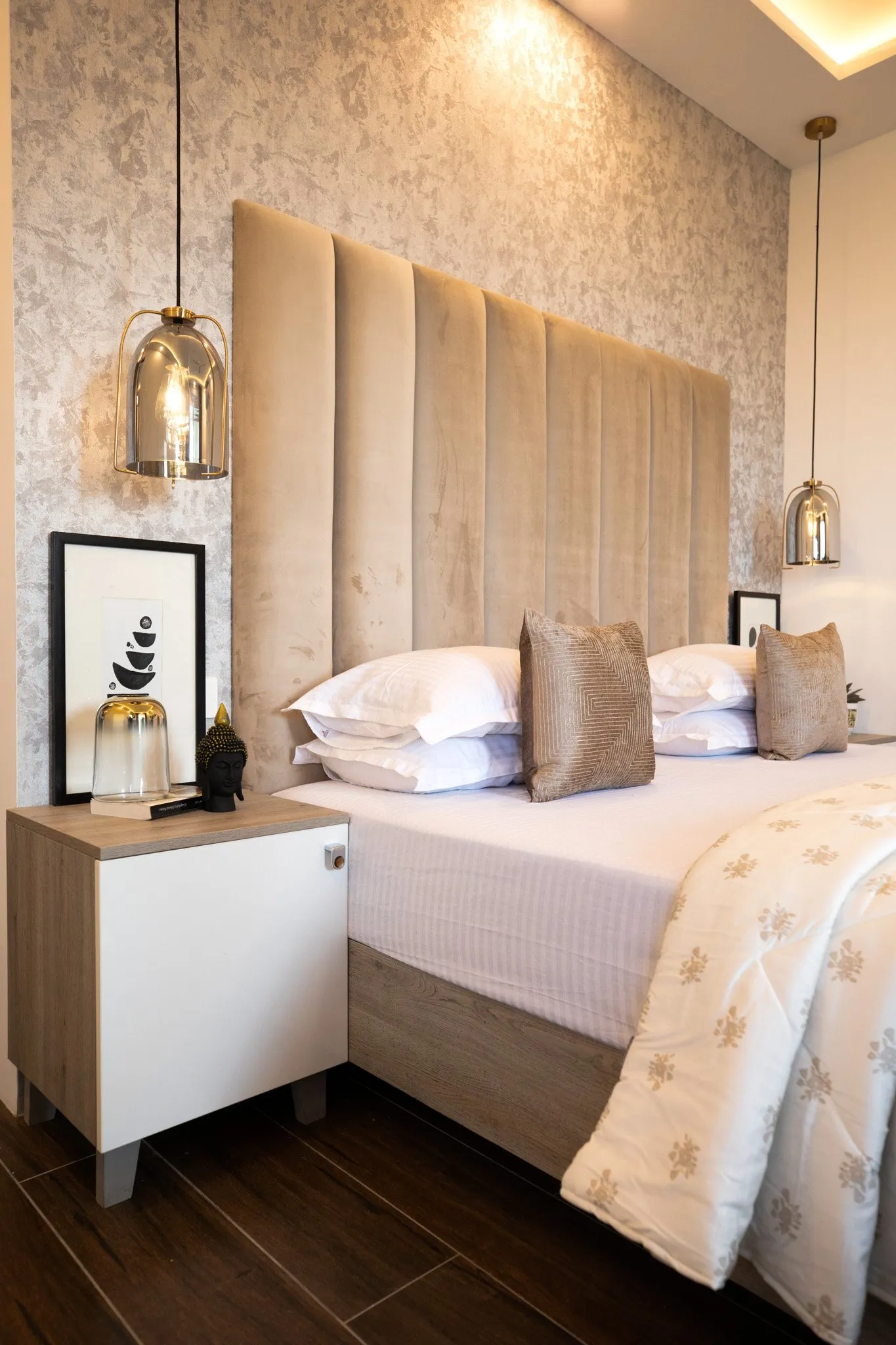 Bedroom with a beige panelled headboard and a pendant light