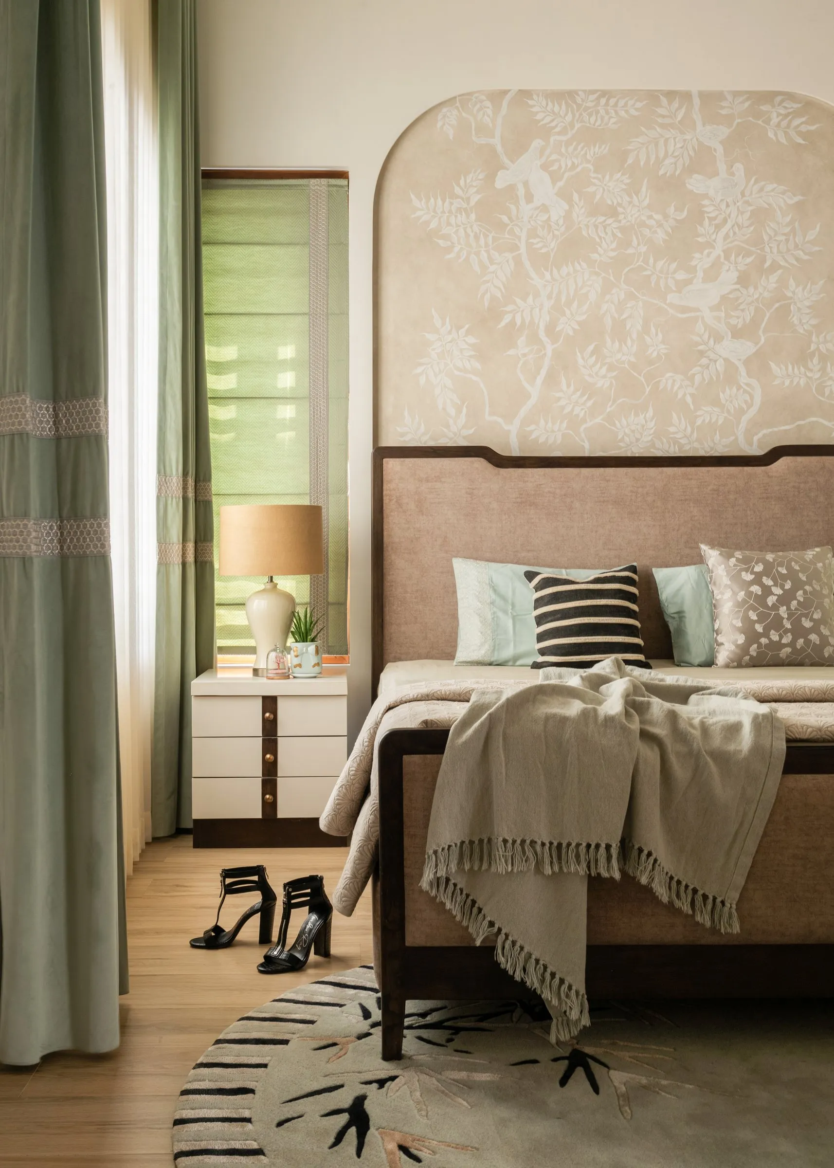 Bedroom with a sage curtain and a floral arched headboard