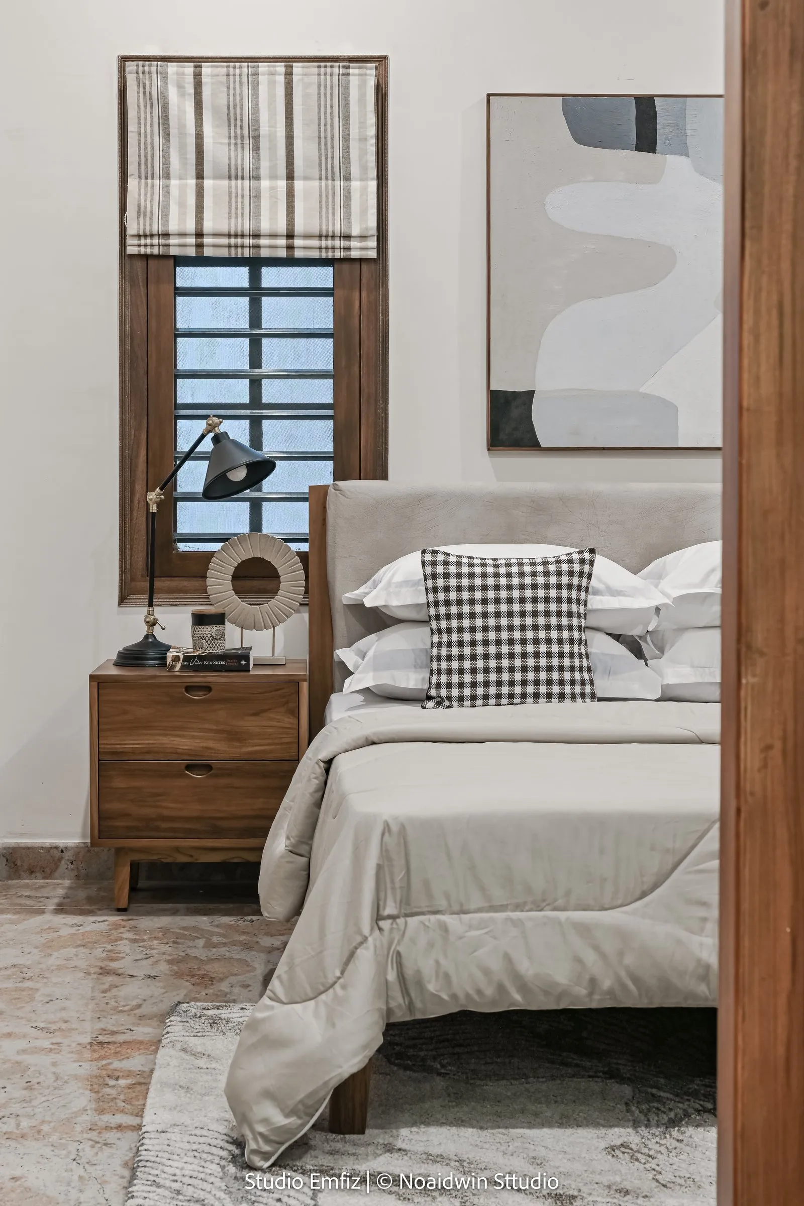 Bedroom with a checked cushion and a wooden side table