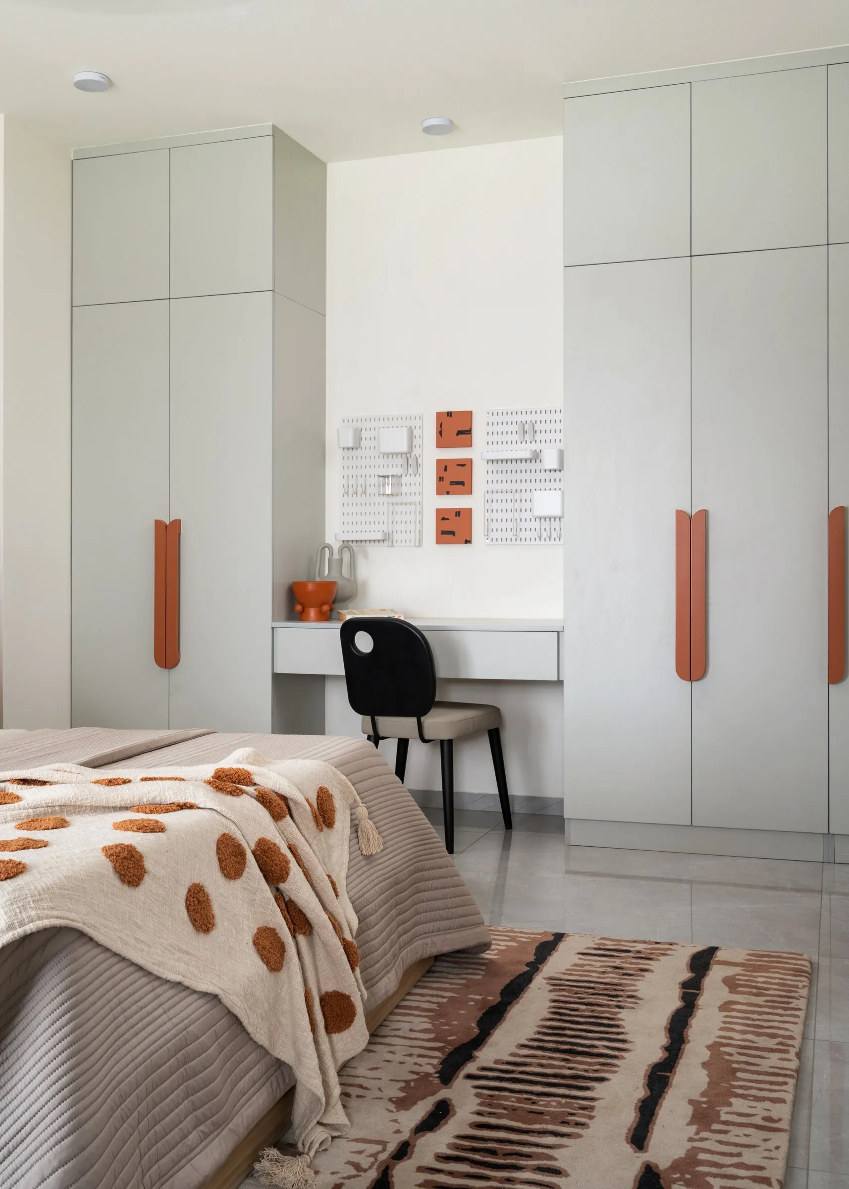 Bedroom with white wardrobes and a study desk