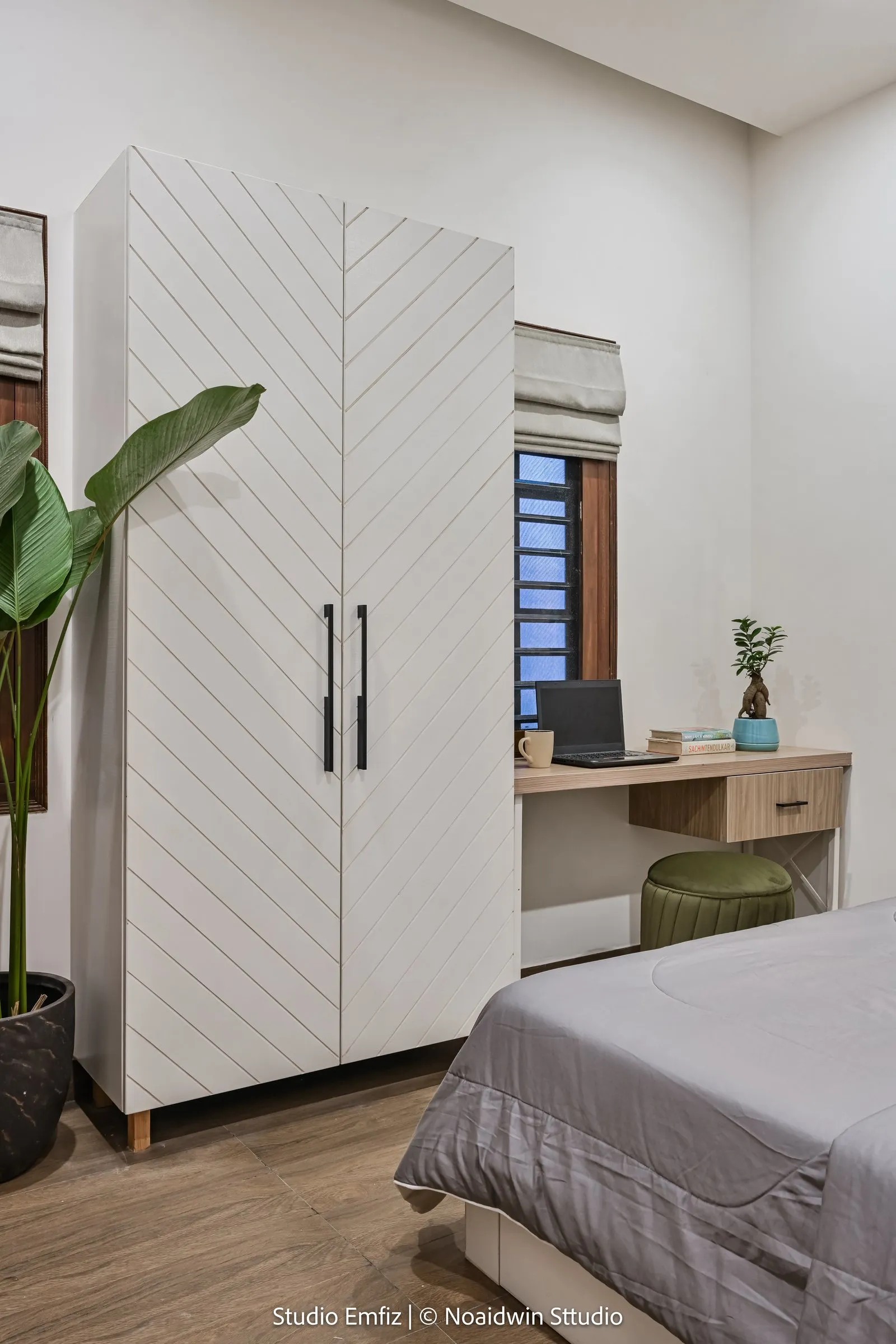 Bedroom with a white chevron wardrobe and a study desk