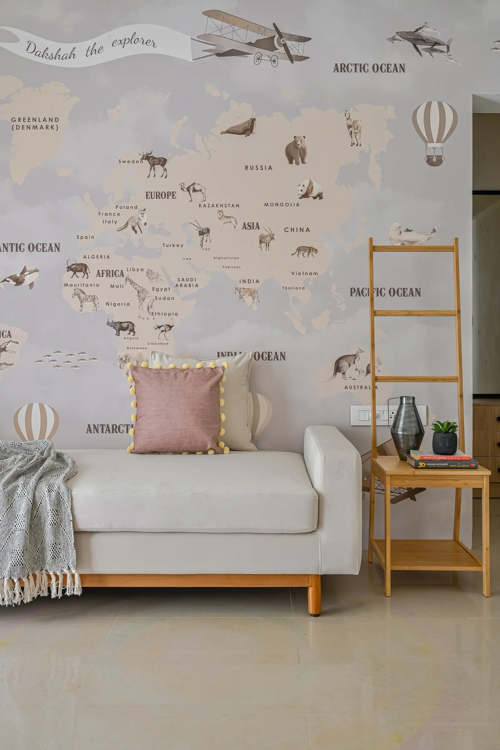 Kids' room with a world map mural and a white daybed