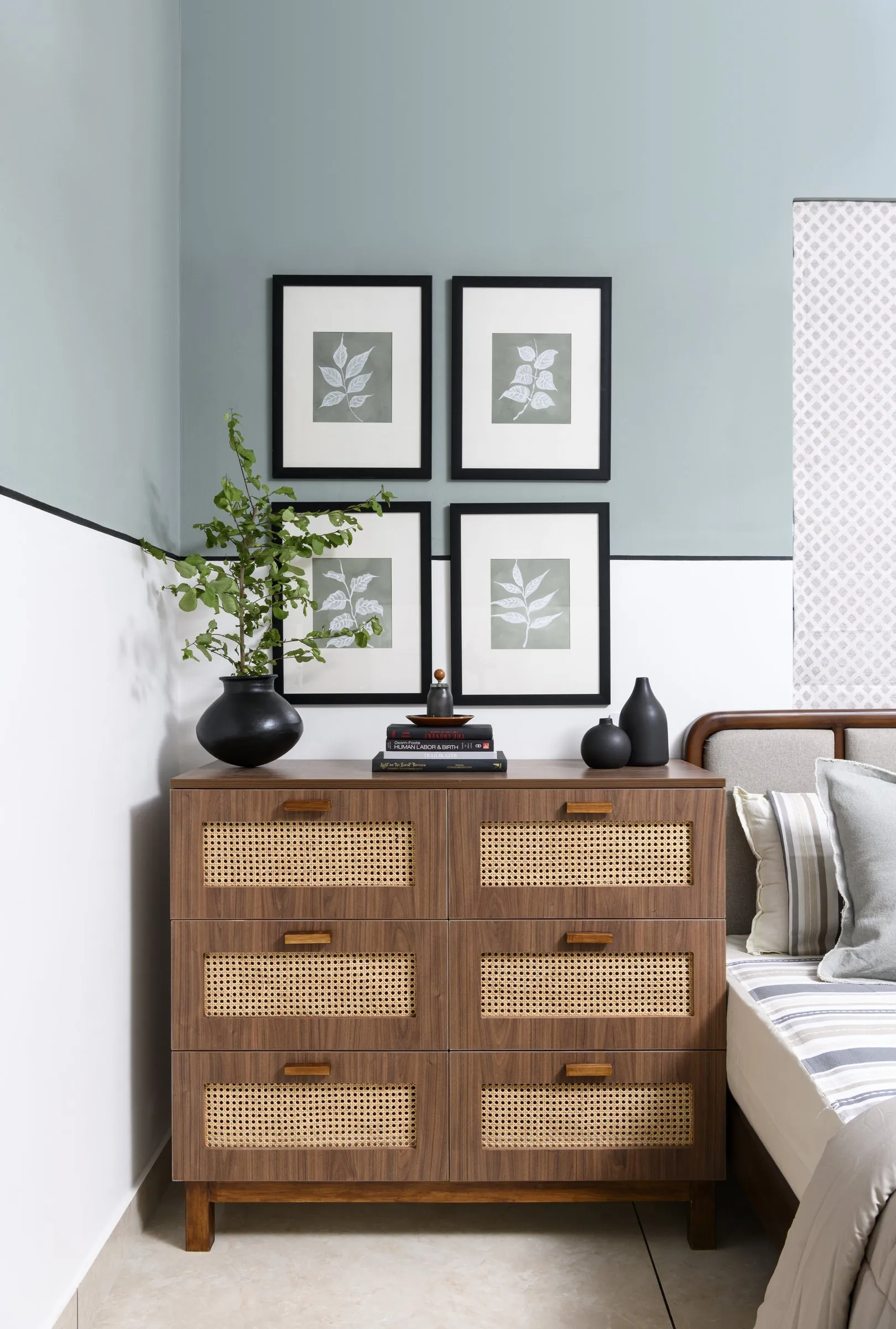 Rattan chest of drawers under framed leaf prints