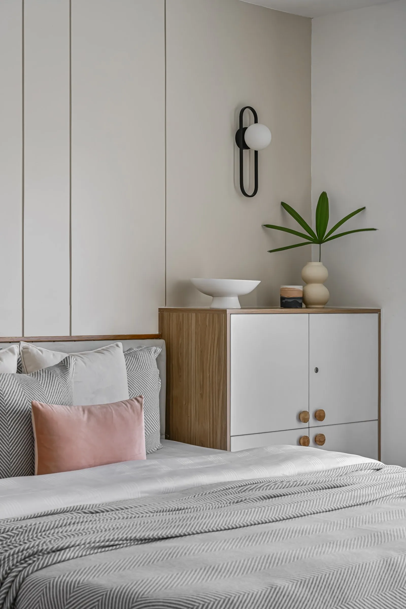 Oak and white bedside chest with a blush cushion