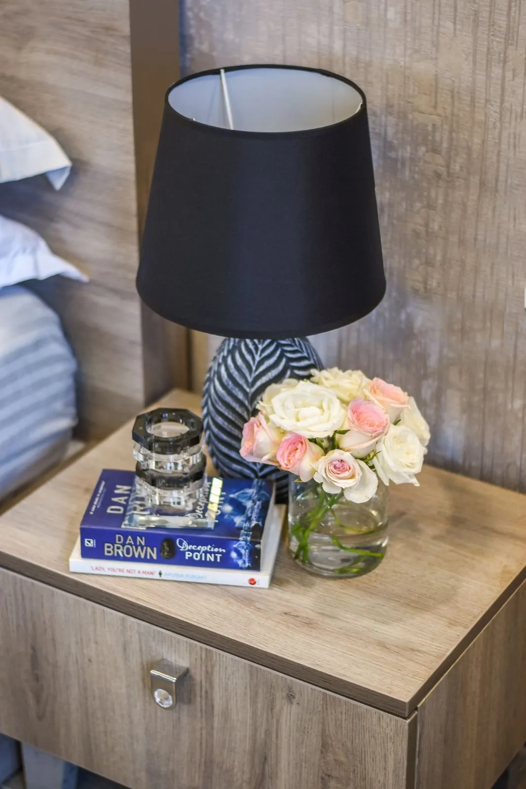 Bedside table with a black lamp