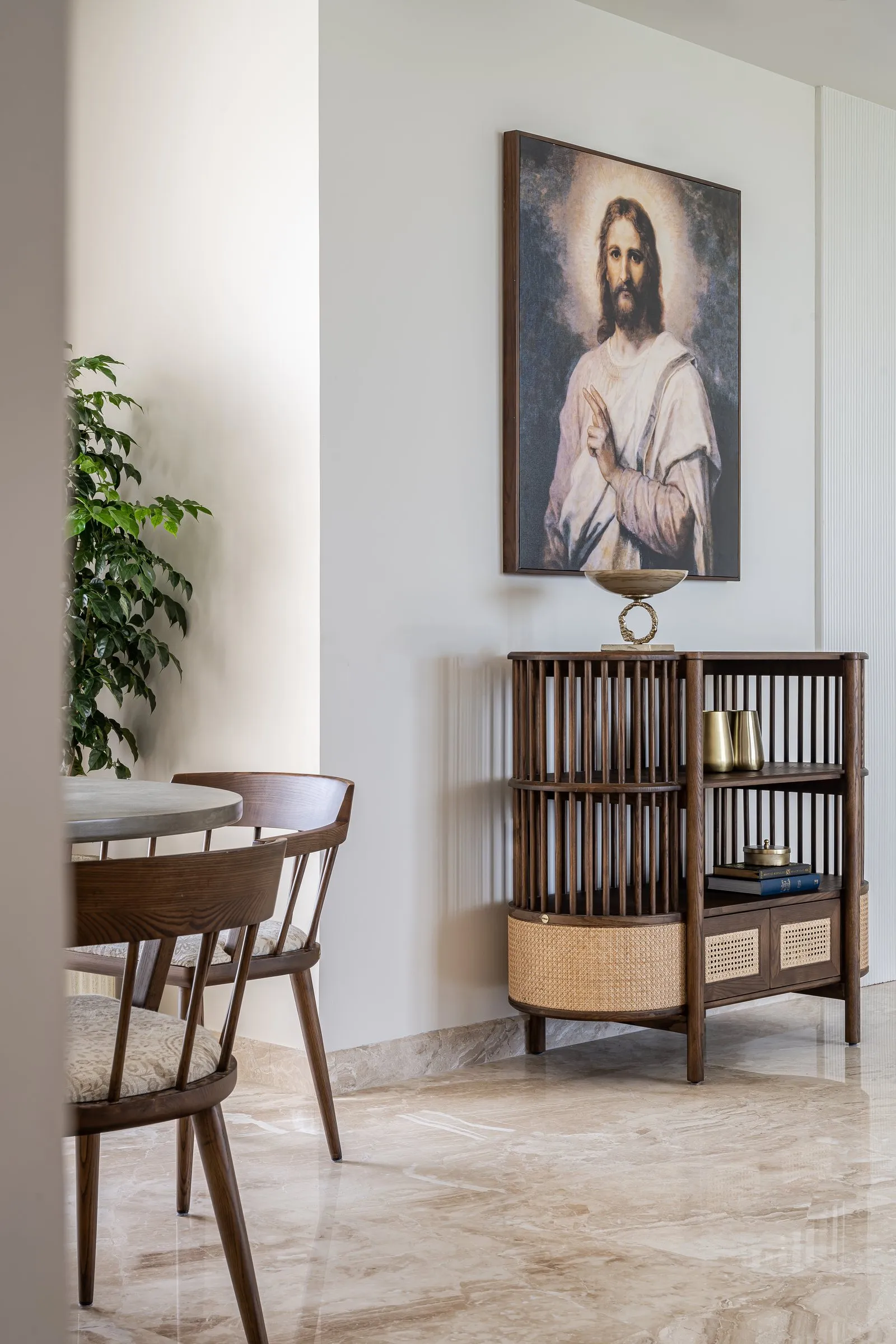 Prayer corner with a painting above a cane and walnut cabinet
