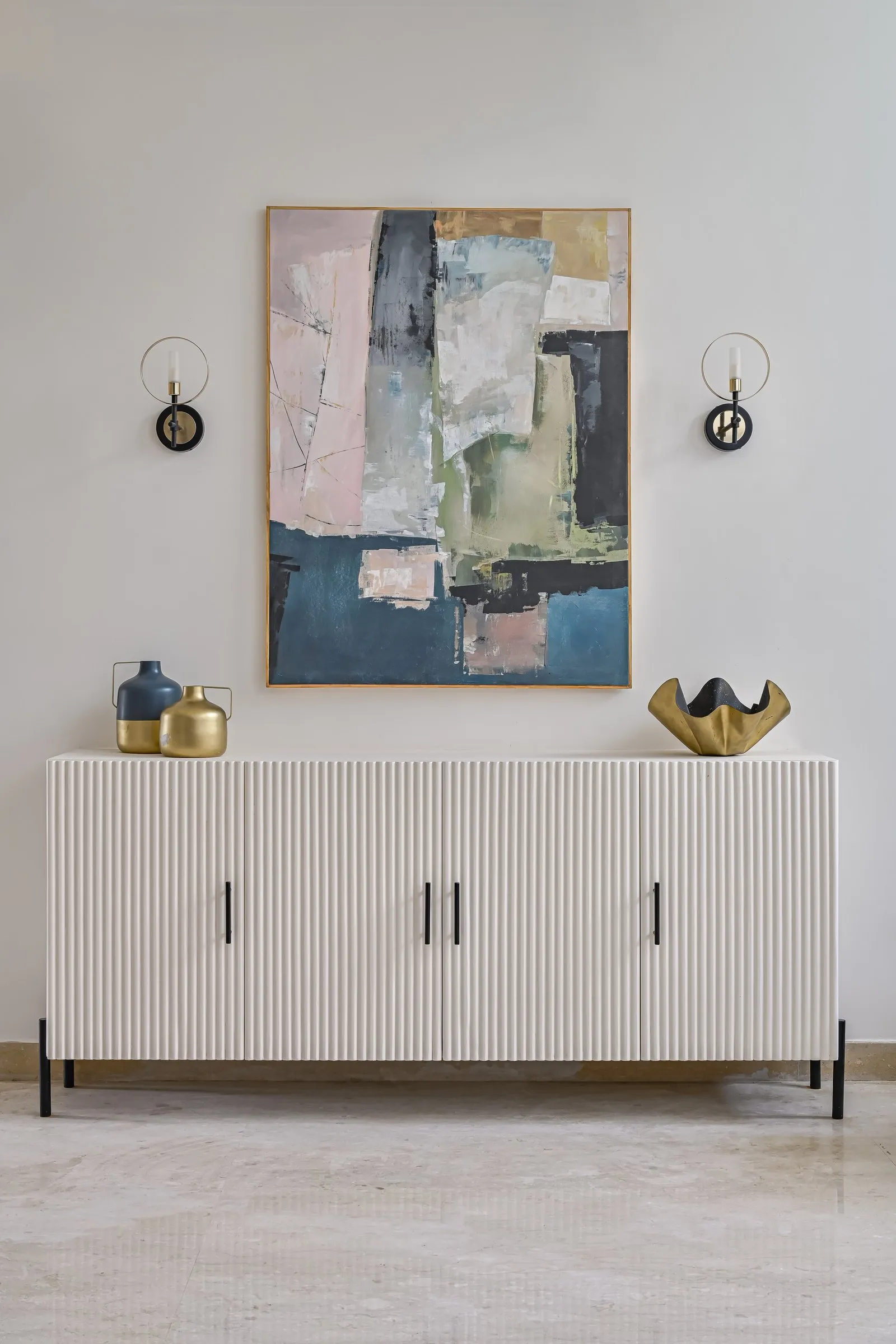 Fluted cream sideboard under an abstract painting
