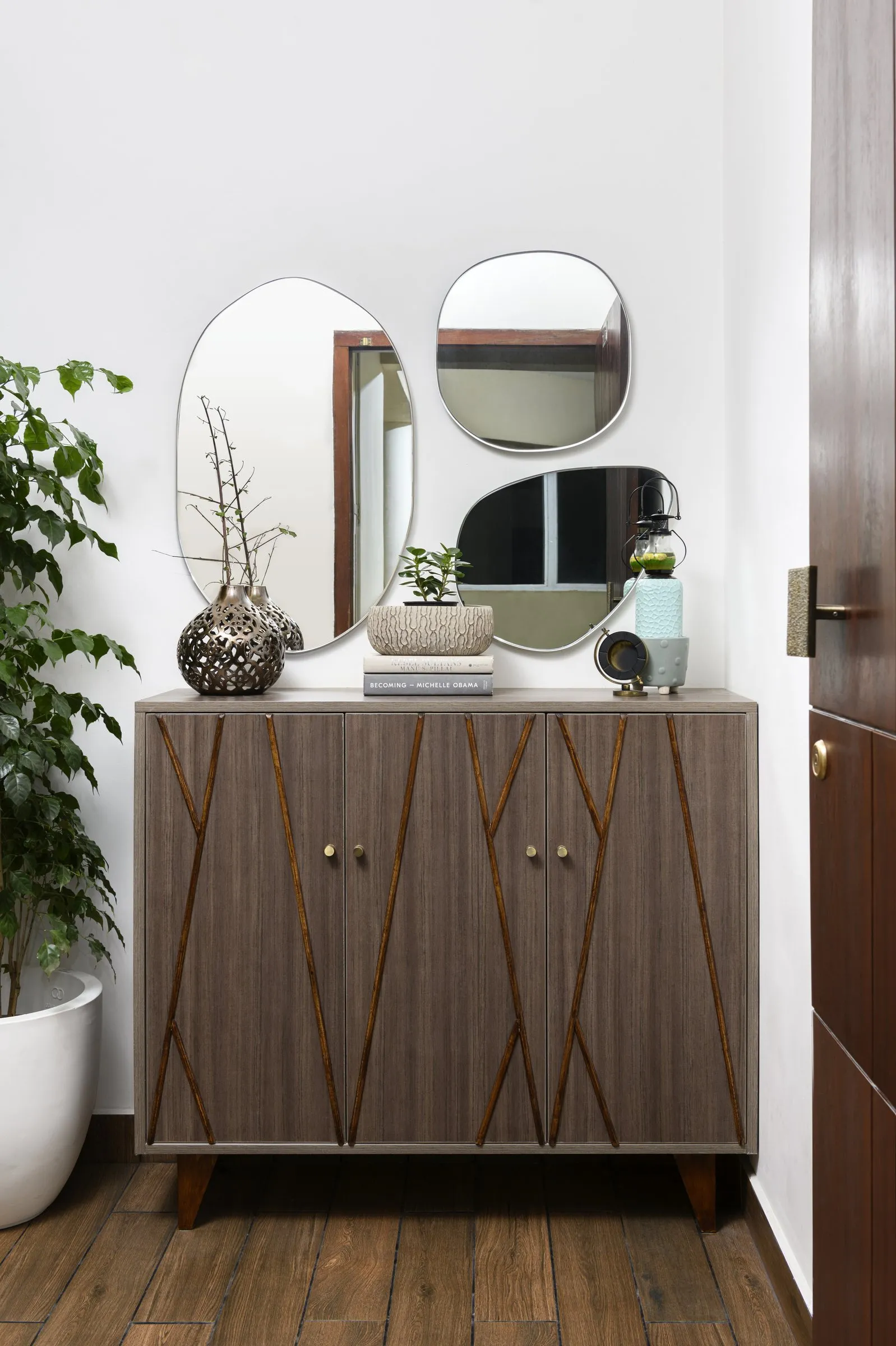 Walnut cabinet with a cluster of round mirrors