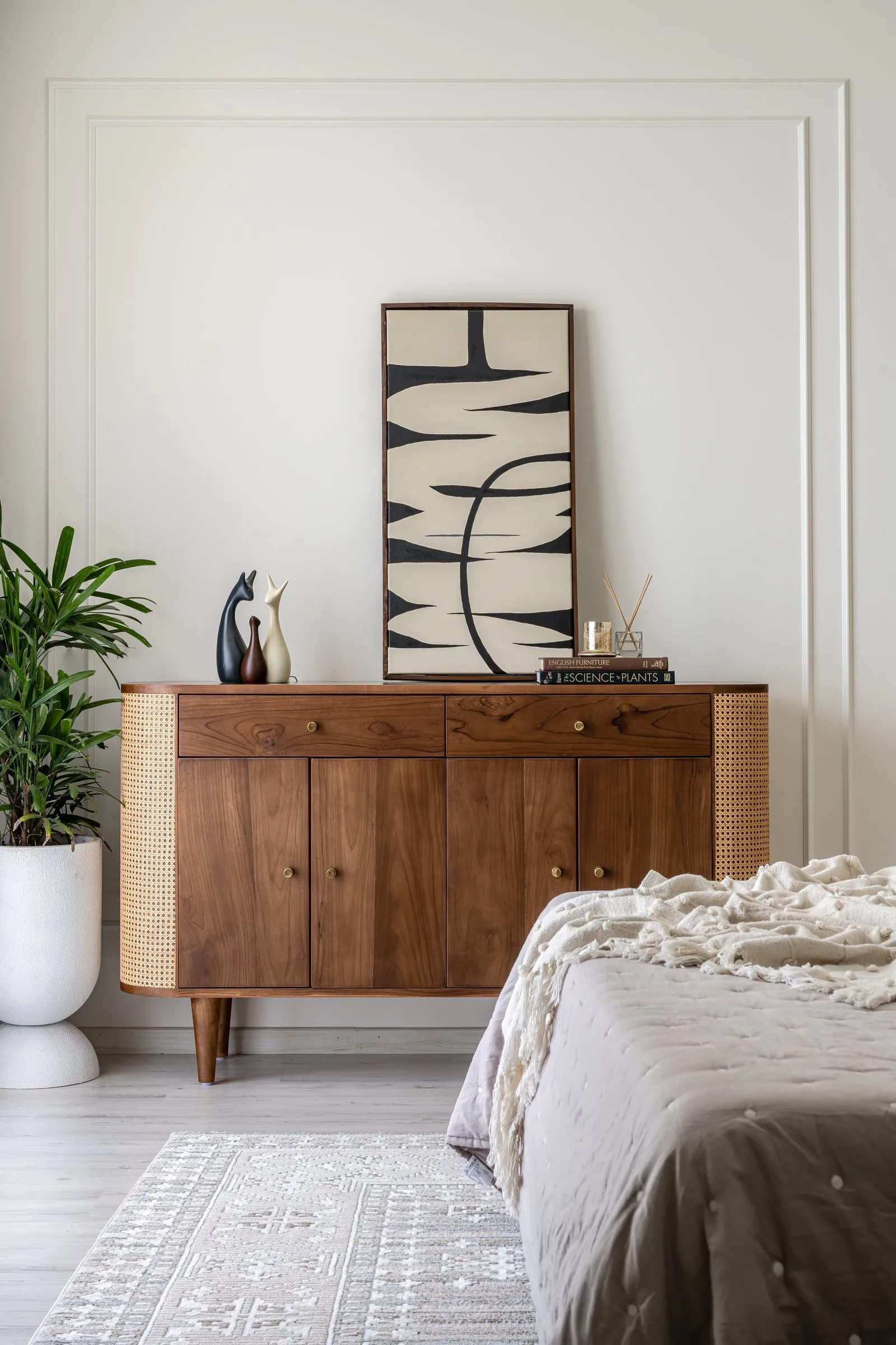 Walnut sideboard with bold black and white art