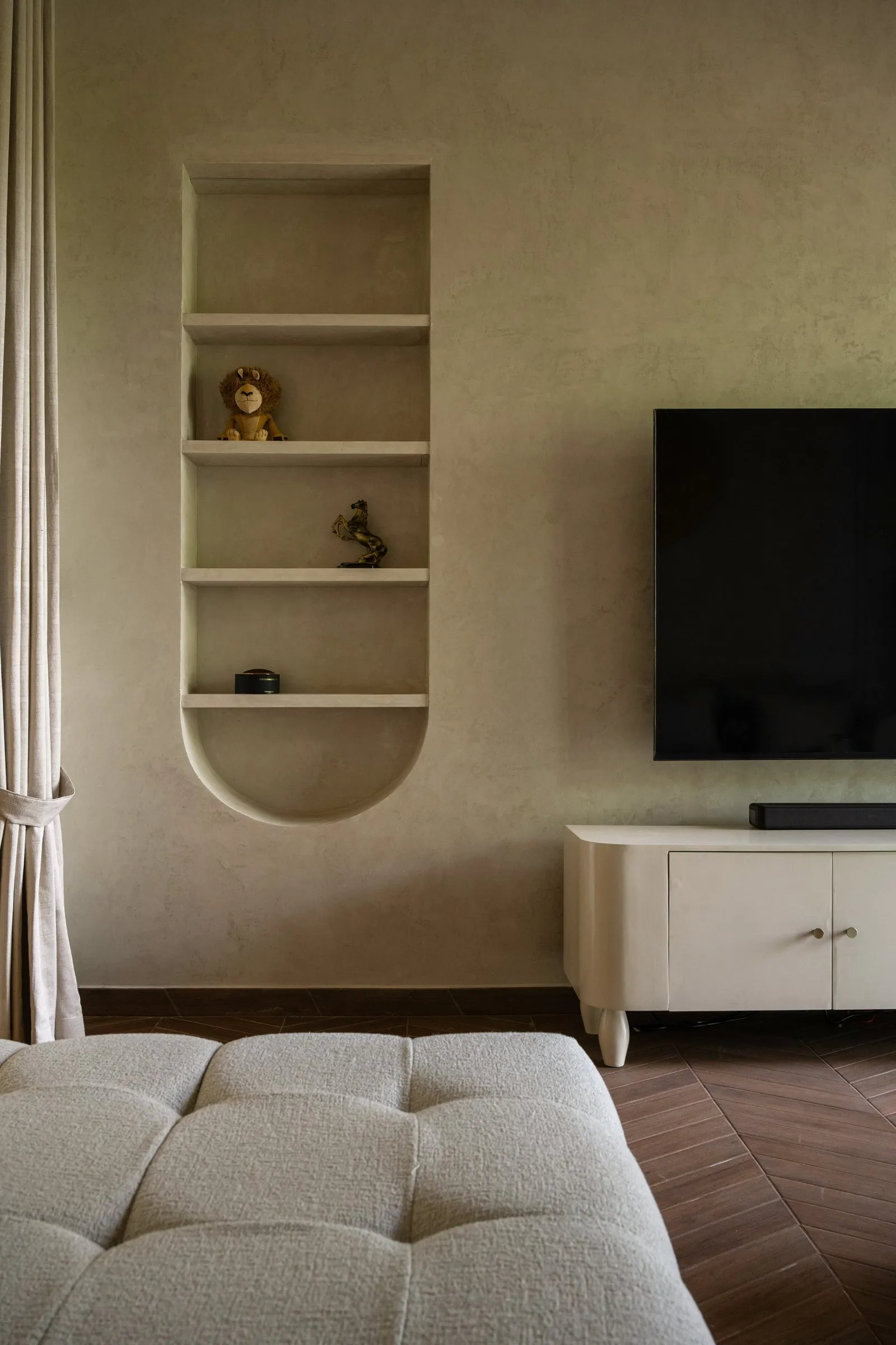Arched wall niche beside the TV