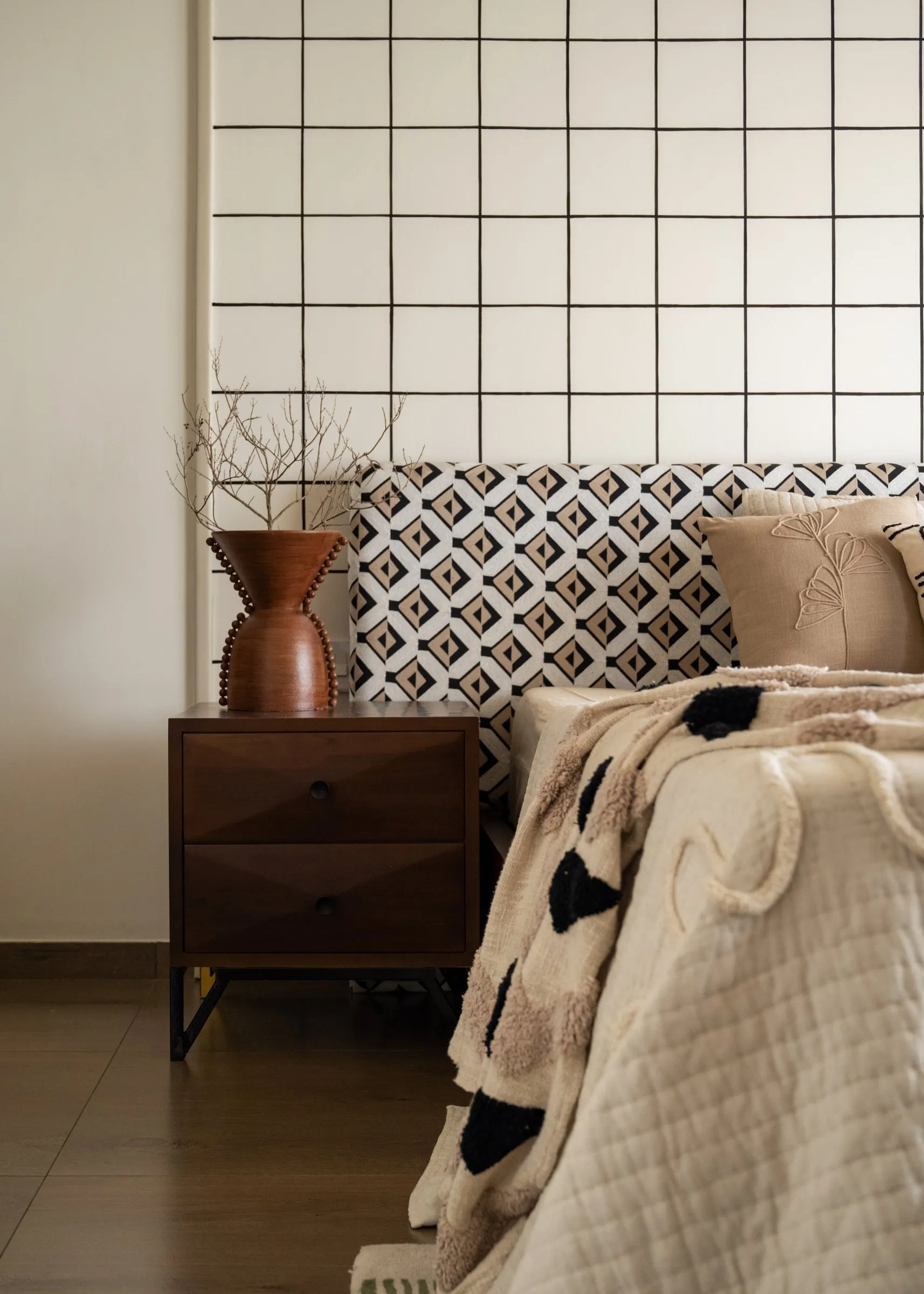 Patterned headboard with a terracotta vase