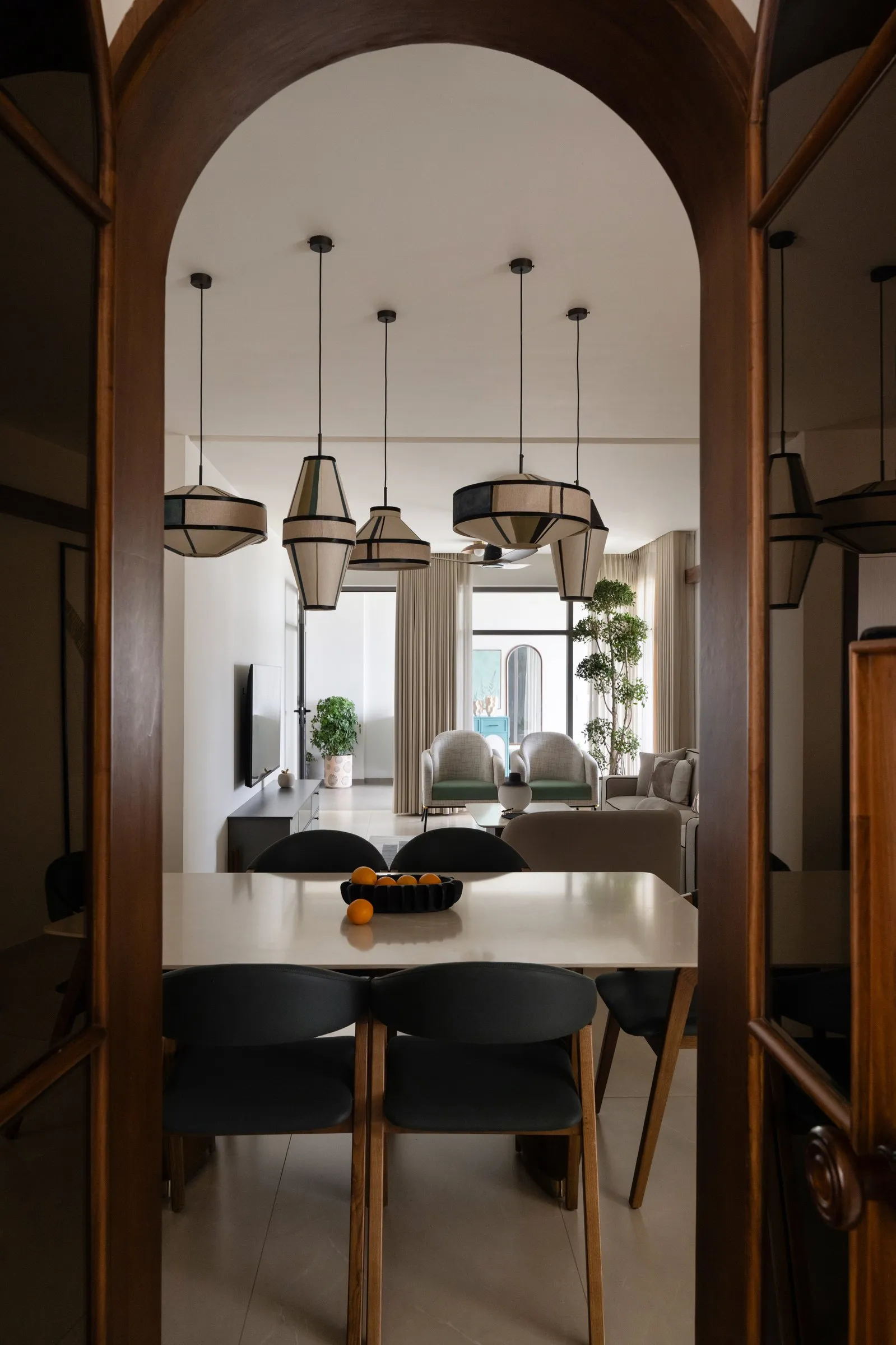 Dining room seen through a tall walnut arch