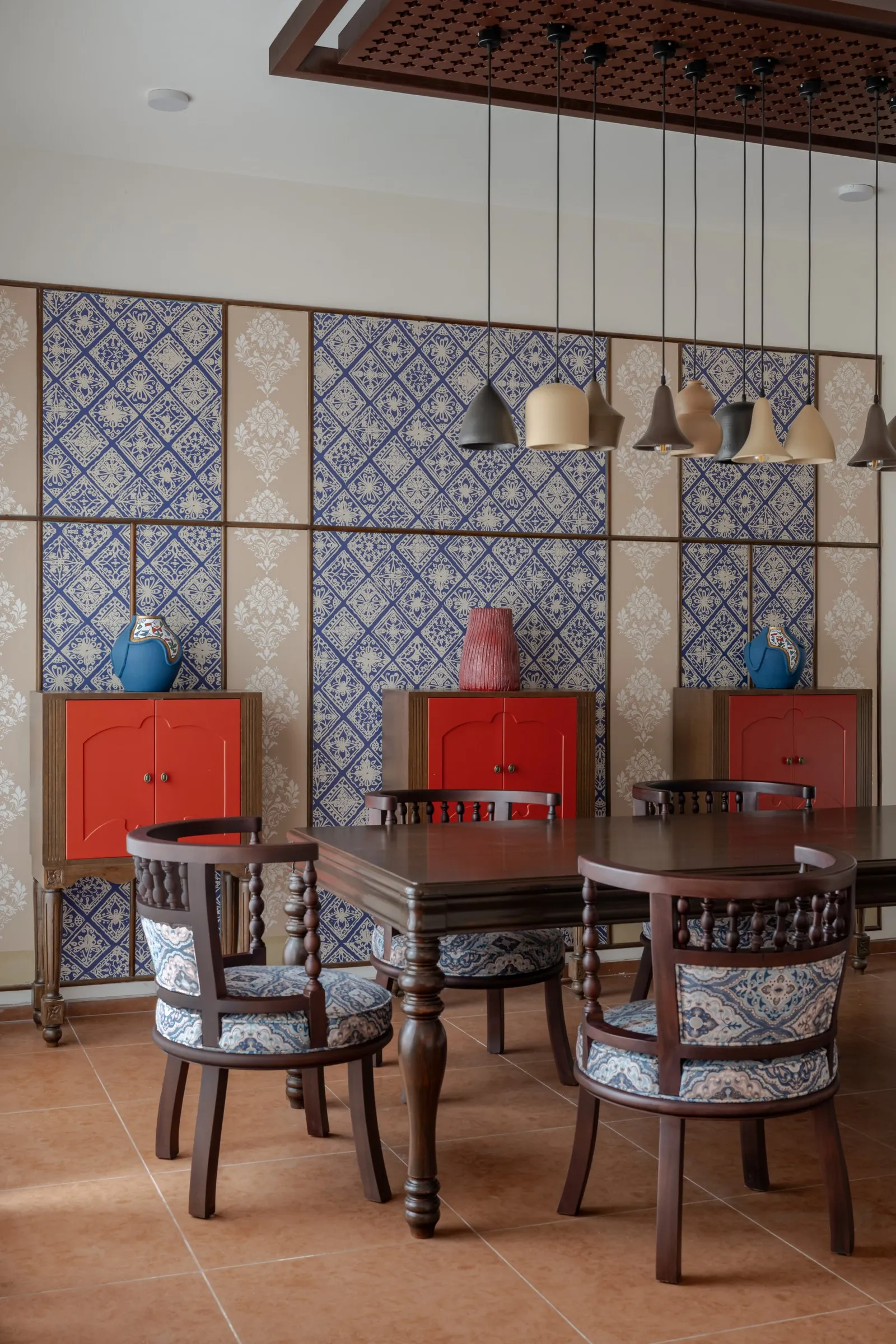 Blue patterned wall panels behind red cabinets