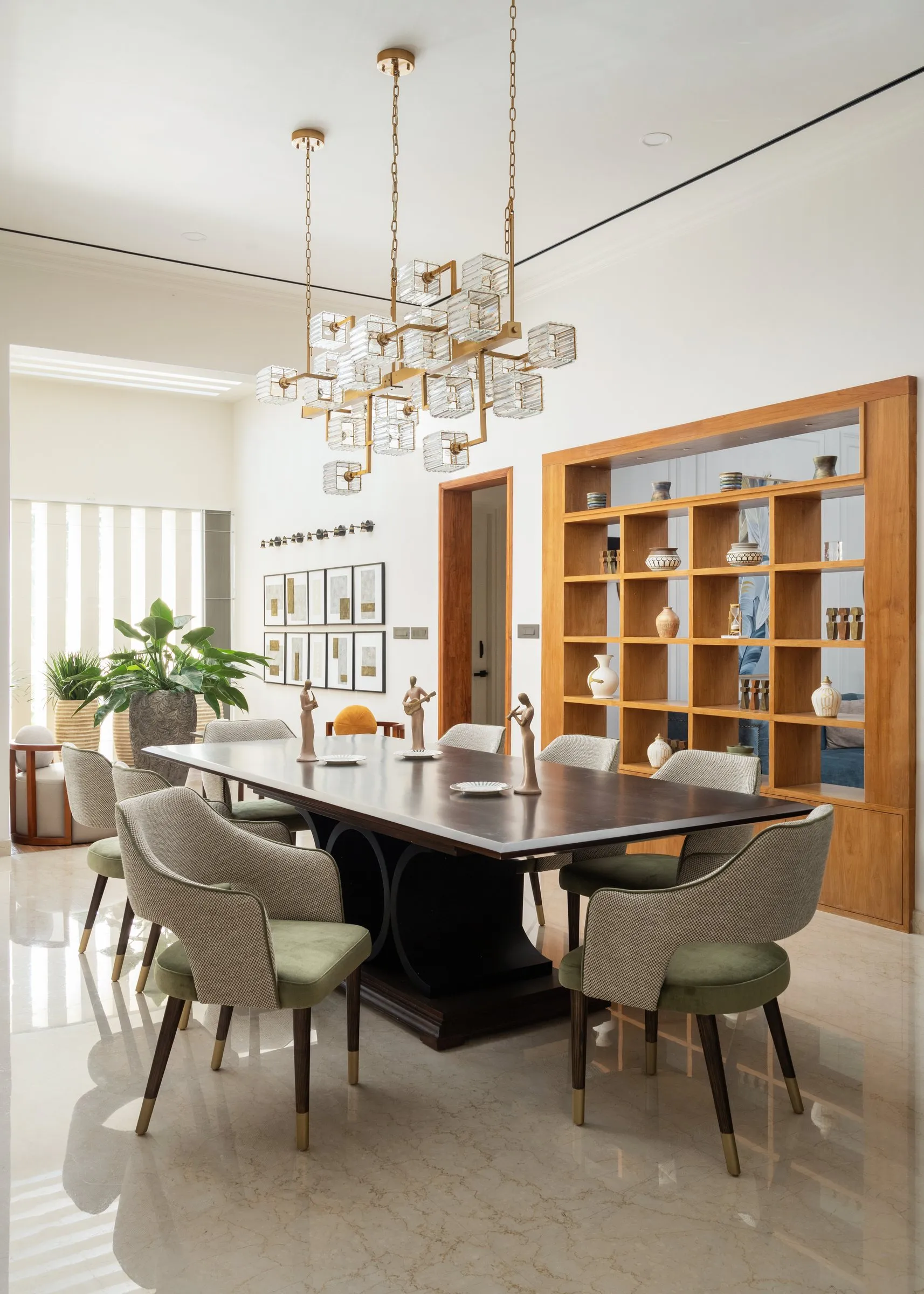 Dining room with teak shelves and green chairs