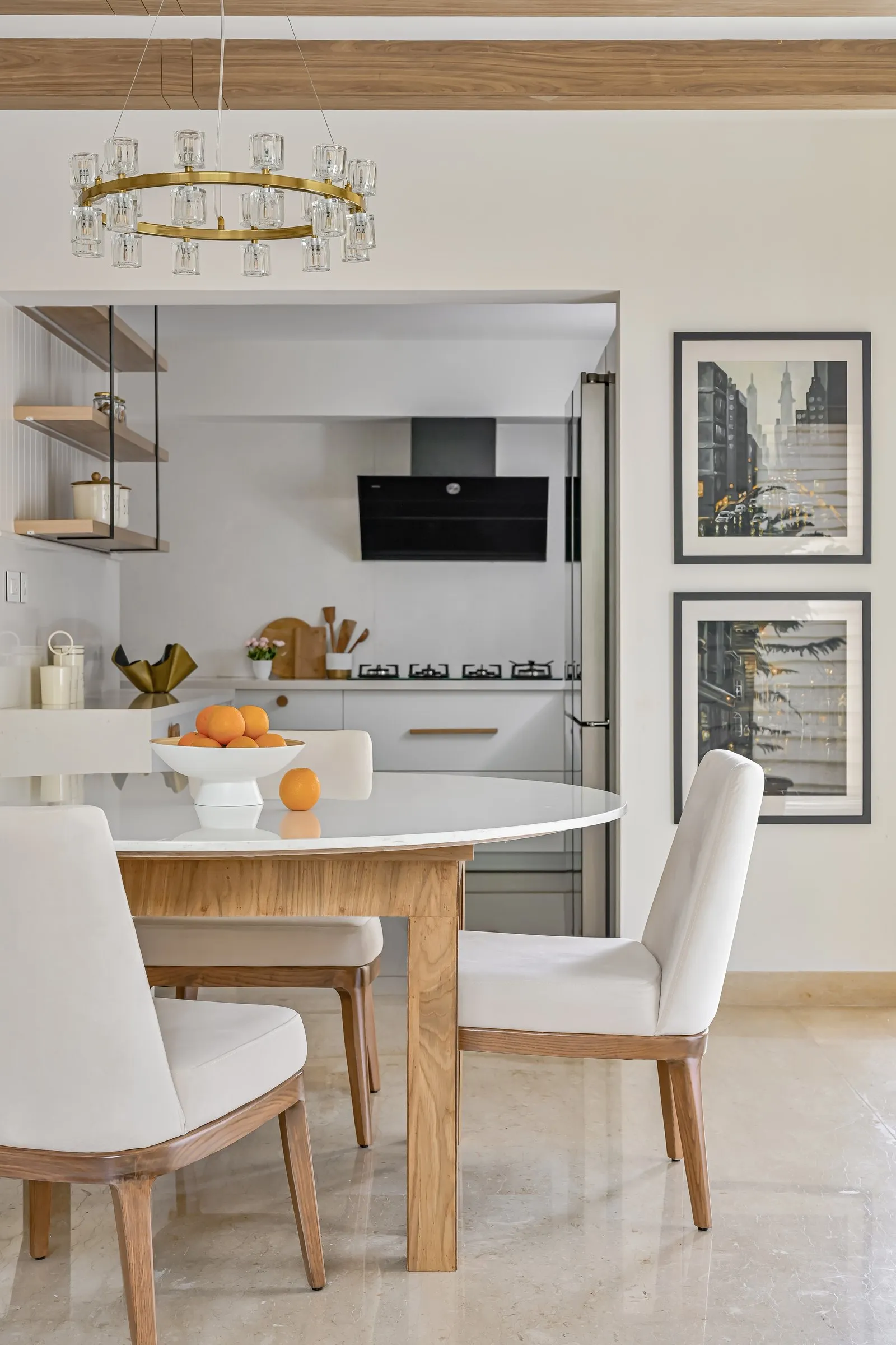 Dining table looking into the kitchen with framed city prints