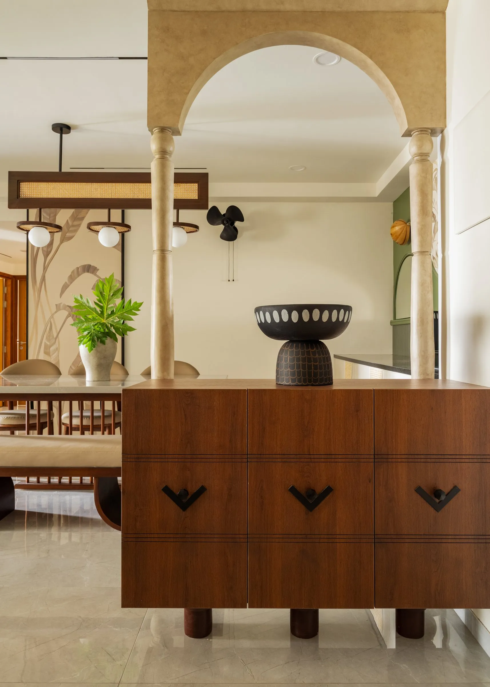 Walnut sideboard under a stone arch