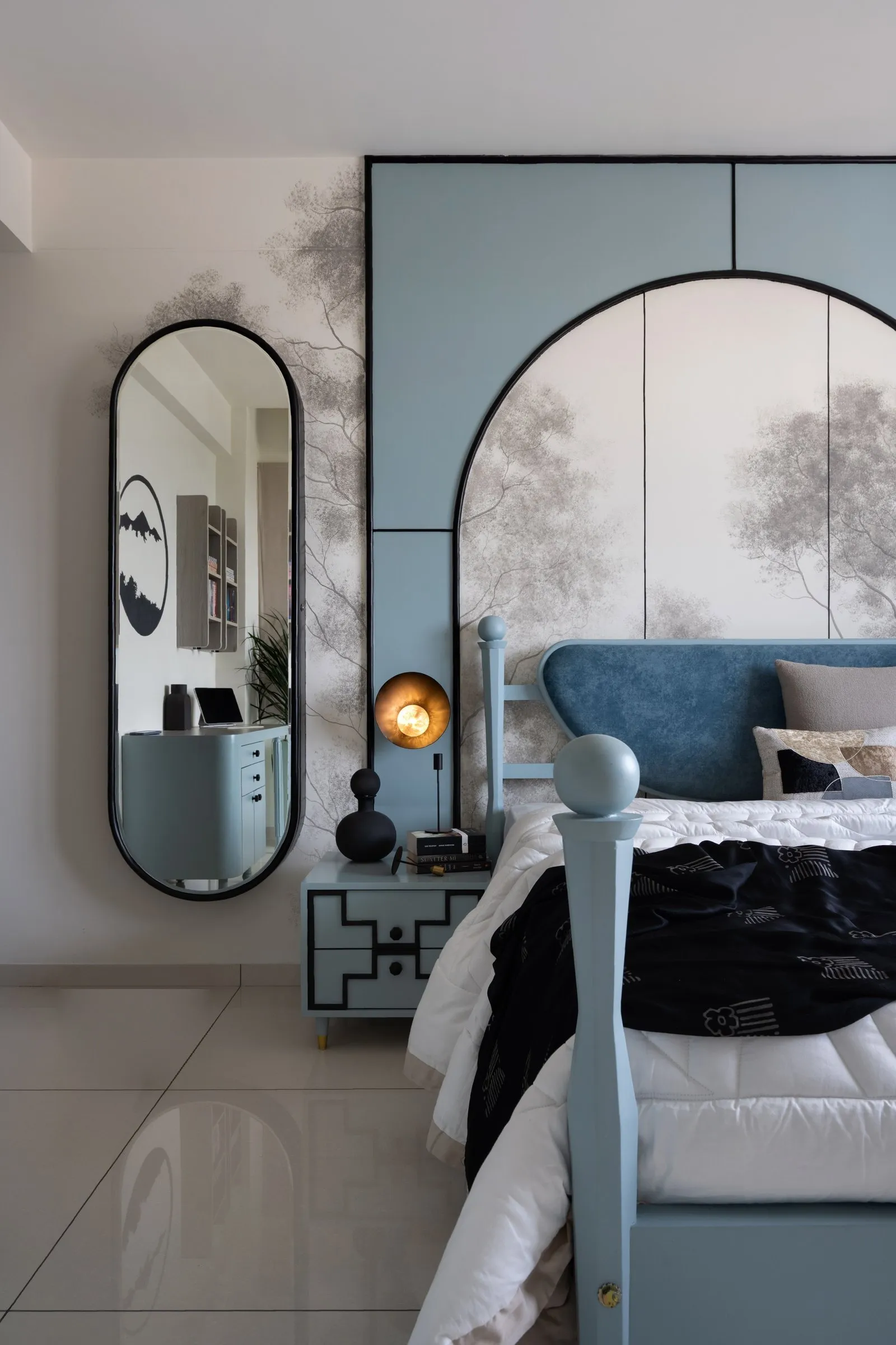 Kids' bedroom with a blue arched headboard wall and a pill-shaped mirror