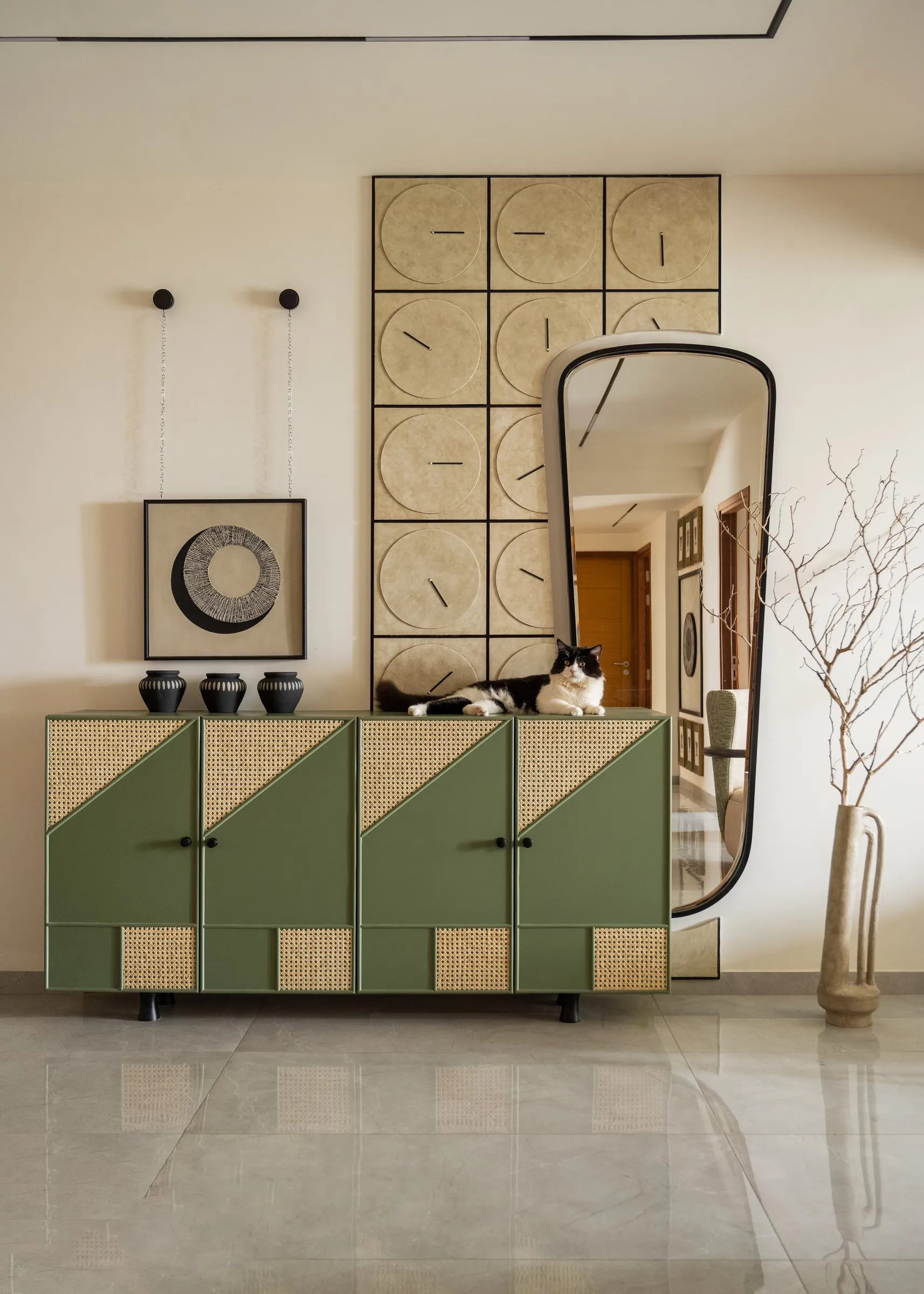 Entrance console in sage and cream with a tall arched mirror
