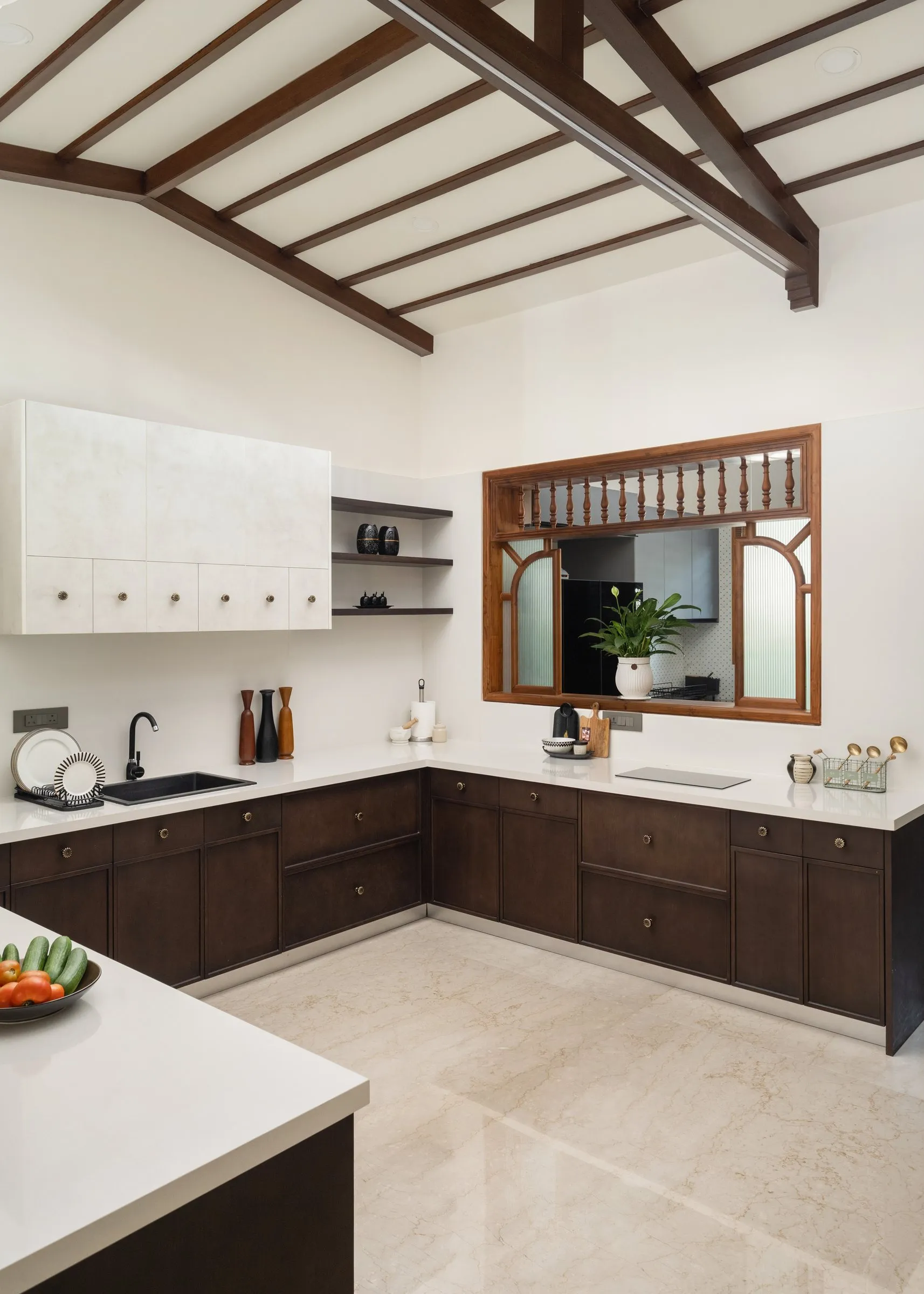 Kitchen with dark wood cabinets under an open timber roof