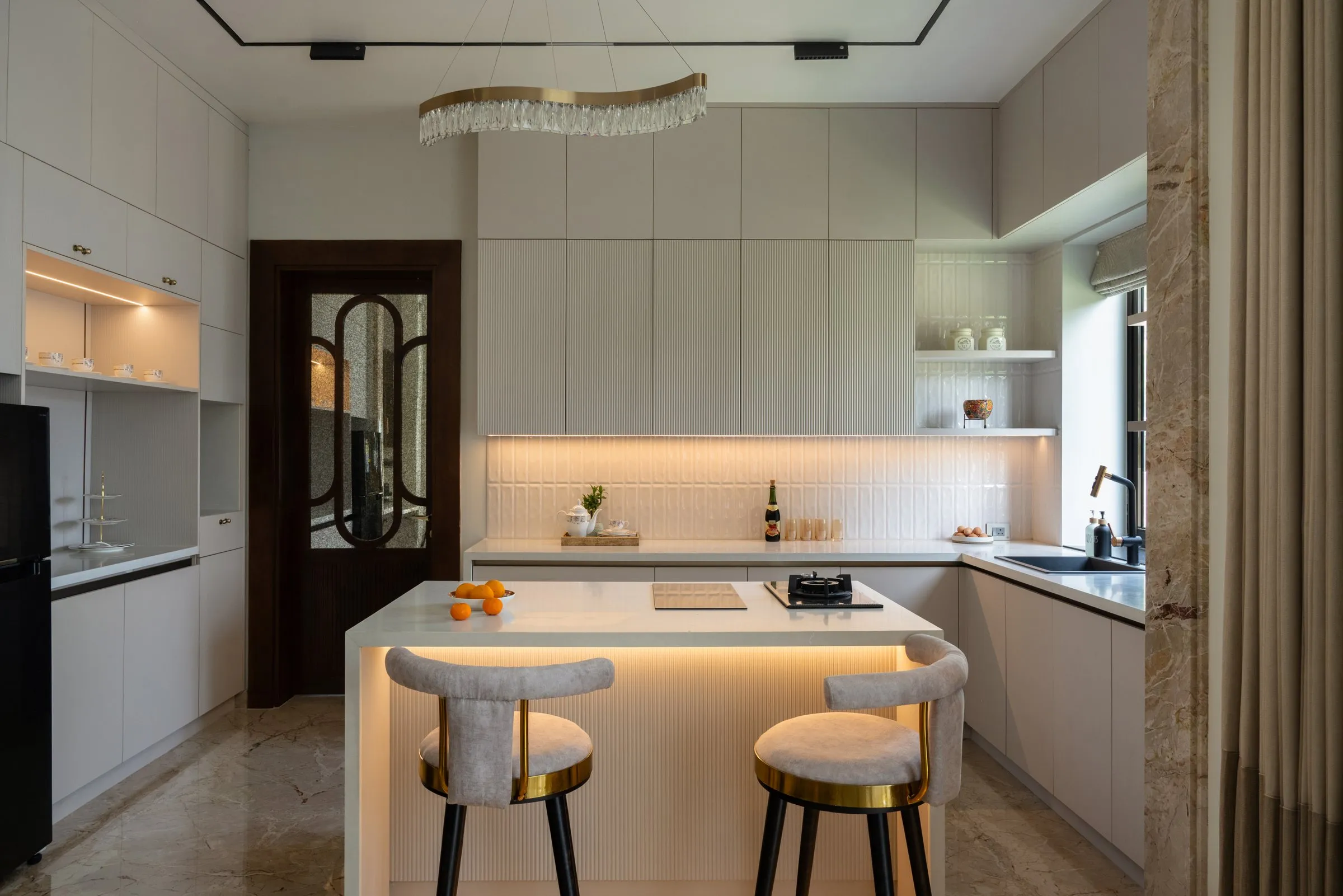 Kitchen with a glowing island and two bar stools