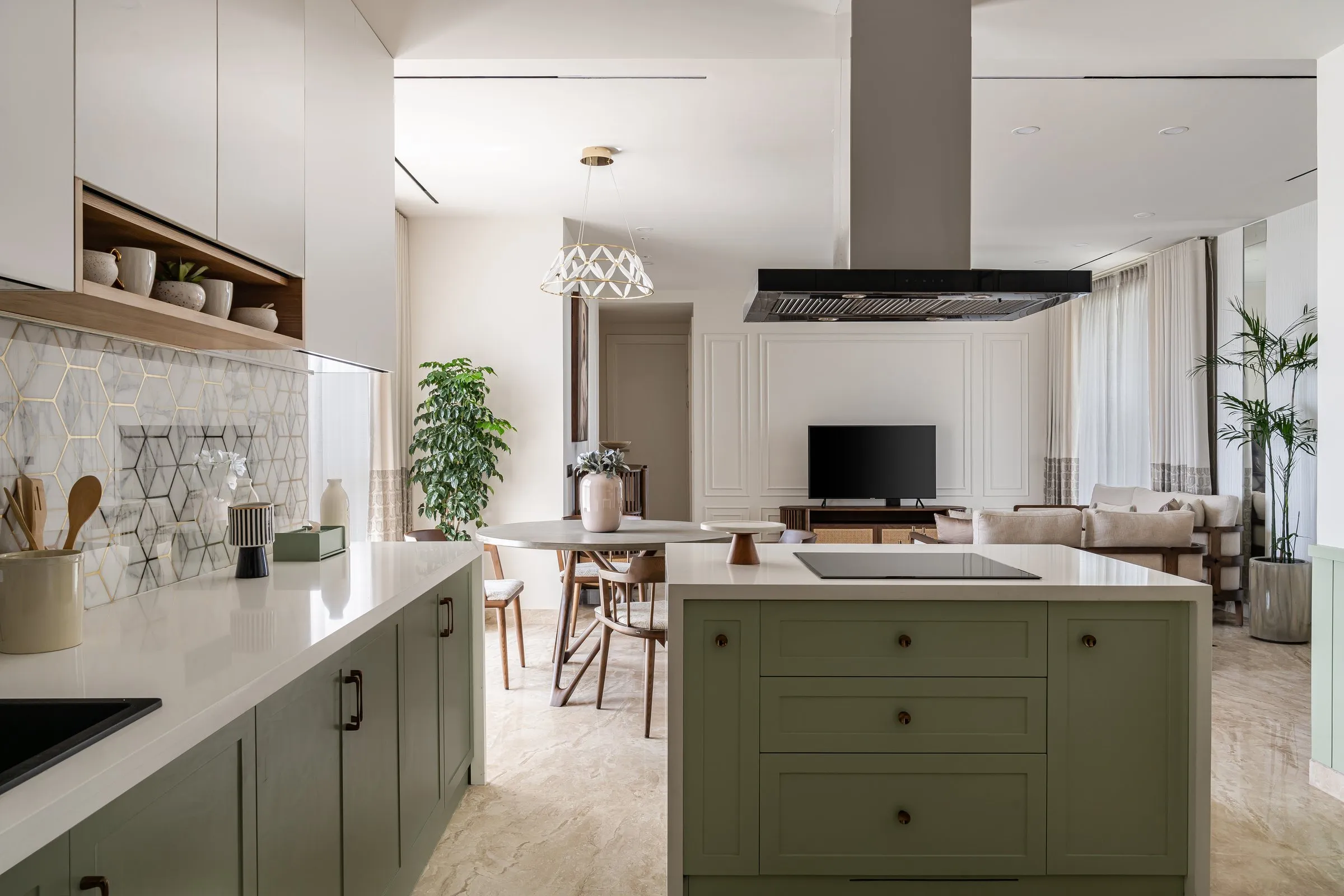 Open kitchen with a sage island looking through to the living room