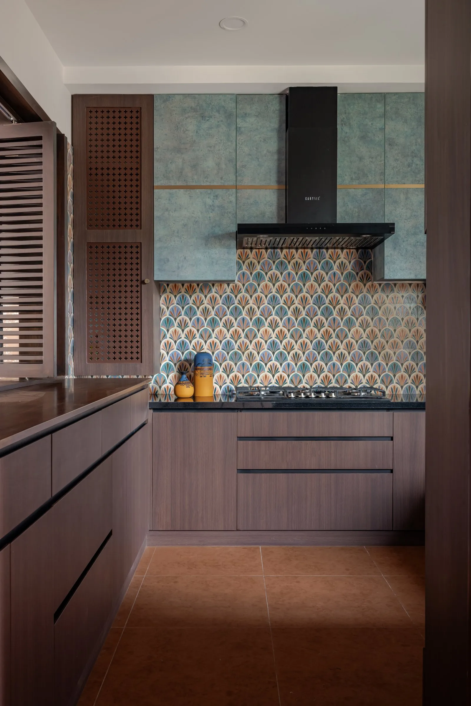 Kitchen with sea-green cabinets and a patterned tile backsplash