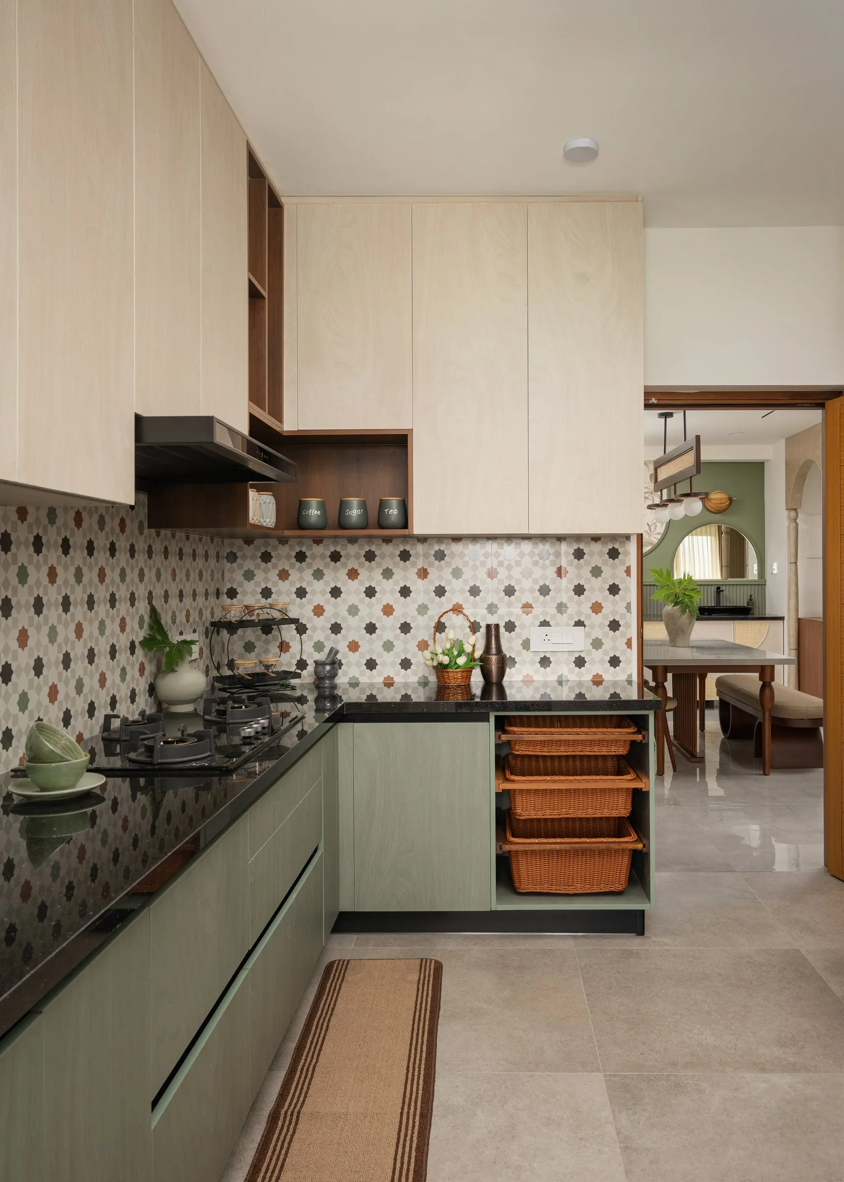 Kitchen with sage cabinets and patterned tiles