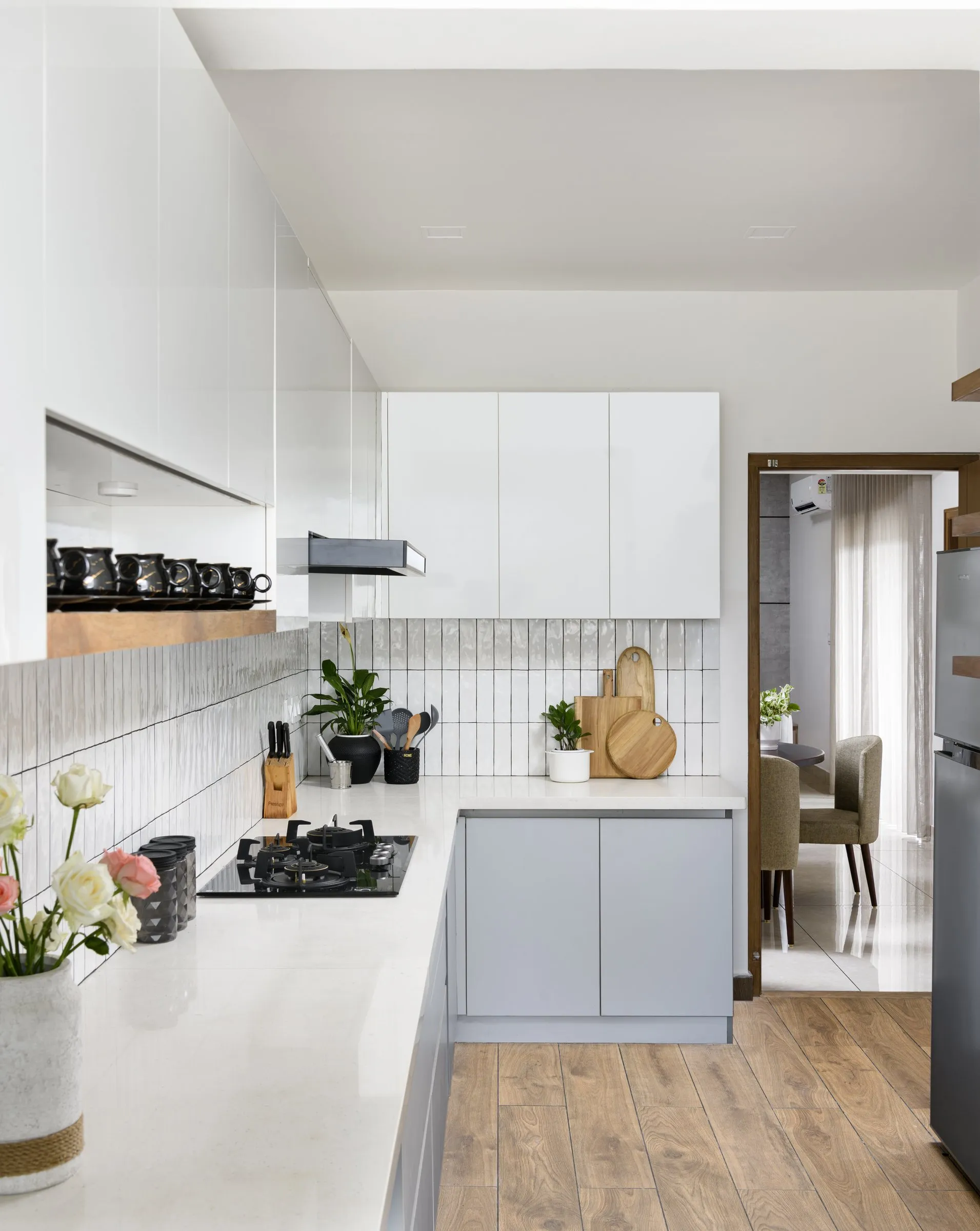 White kitchen with open shelves looking through to the dining room