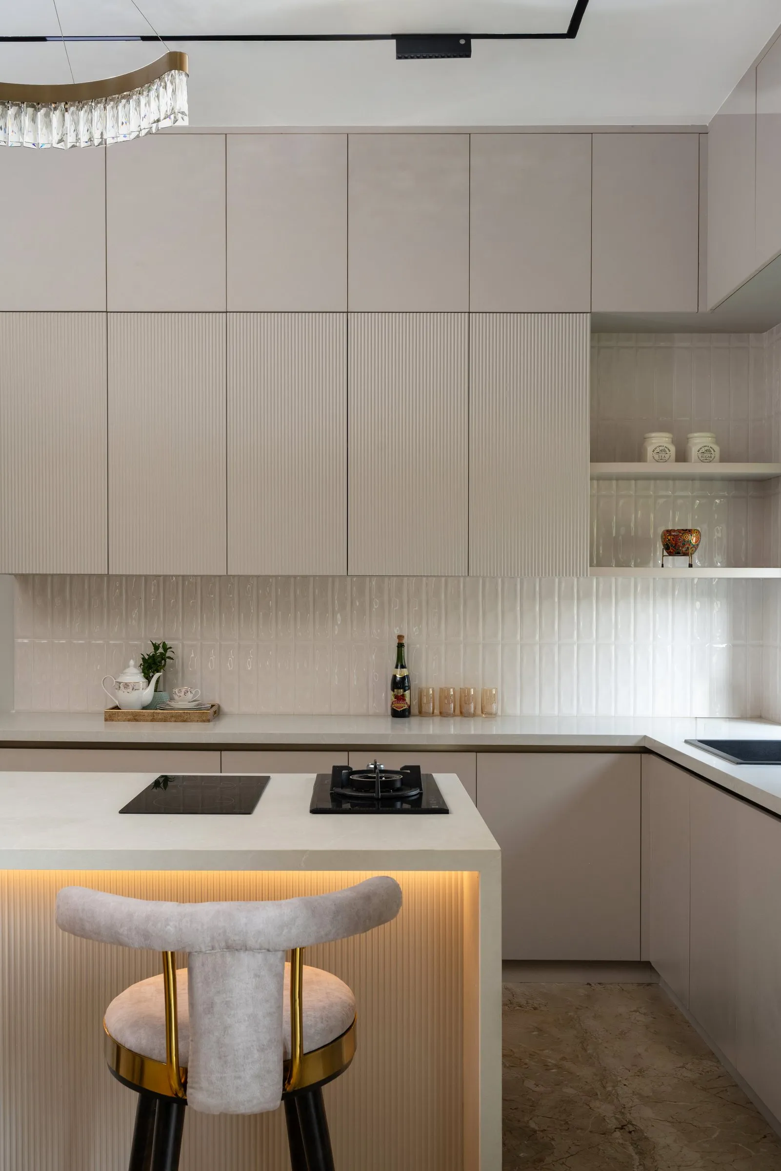 Kitchen island with a sculpted stool and hidden lighting