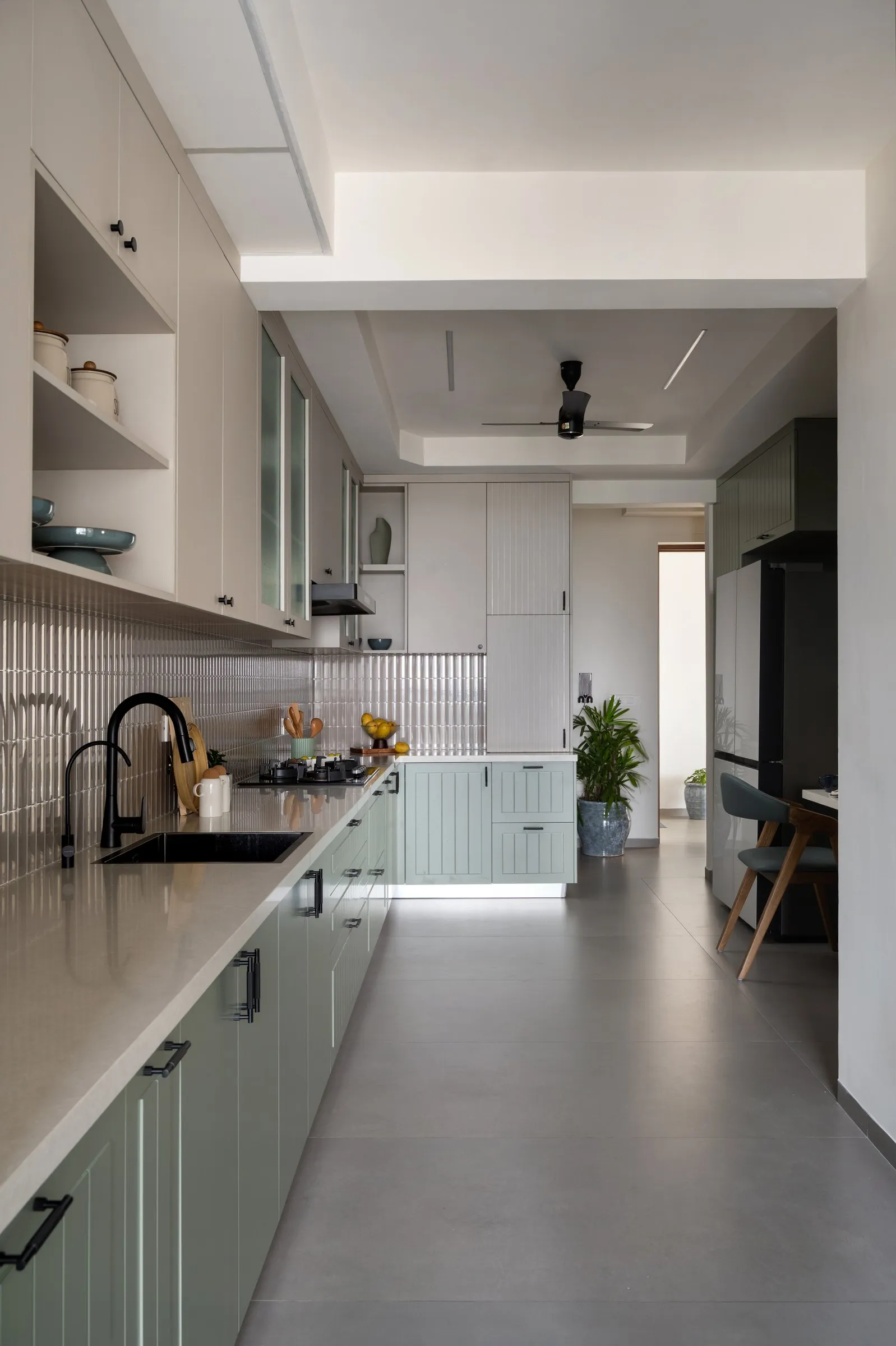 Long galley kitchen with sage lower cabinets