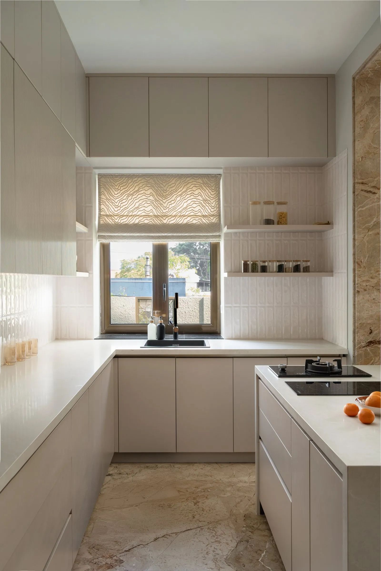 Greige kitchen with a window over the sink