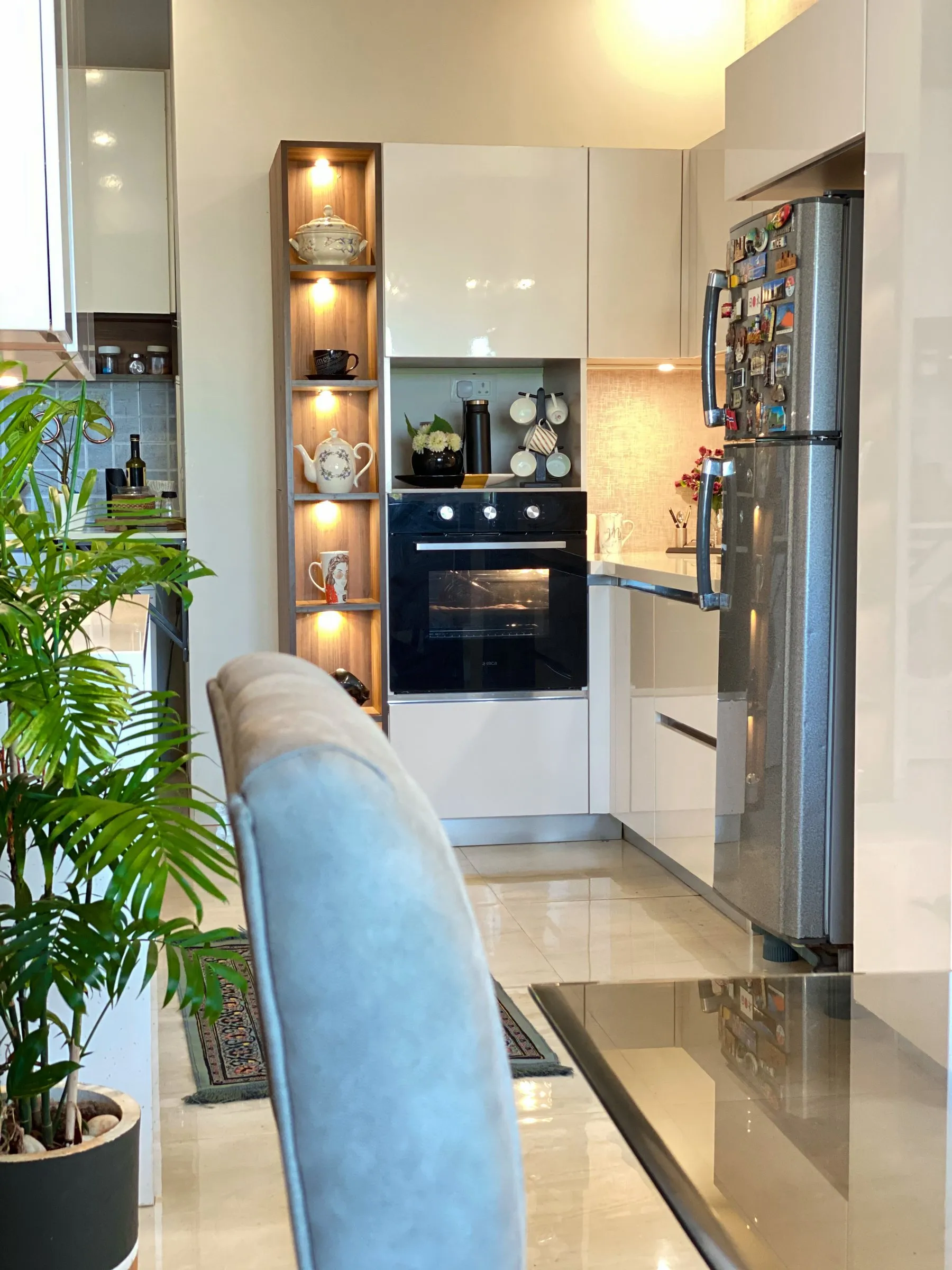 Galley kitchen with a lit shelf column and an oven
