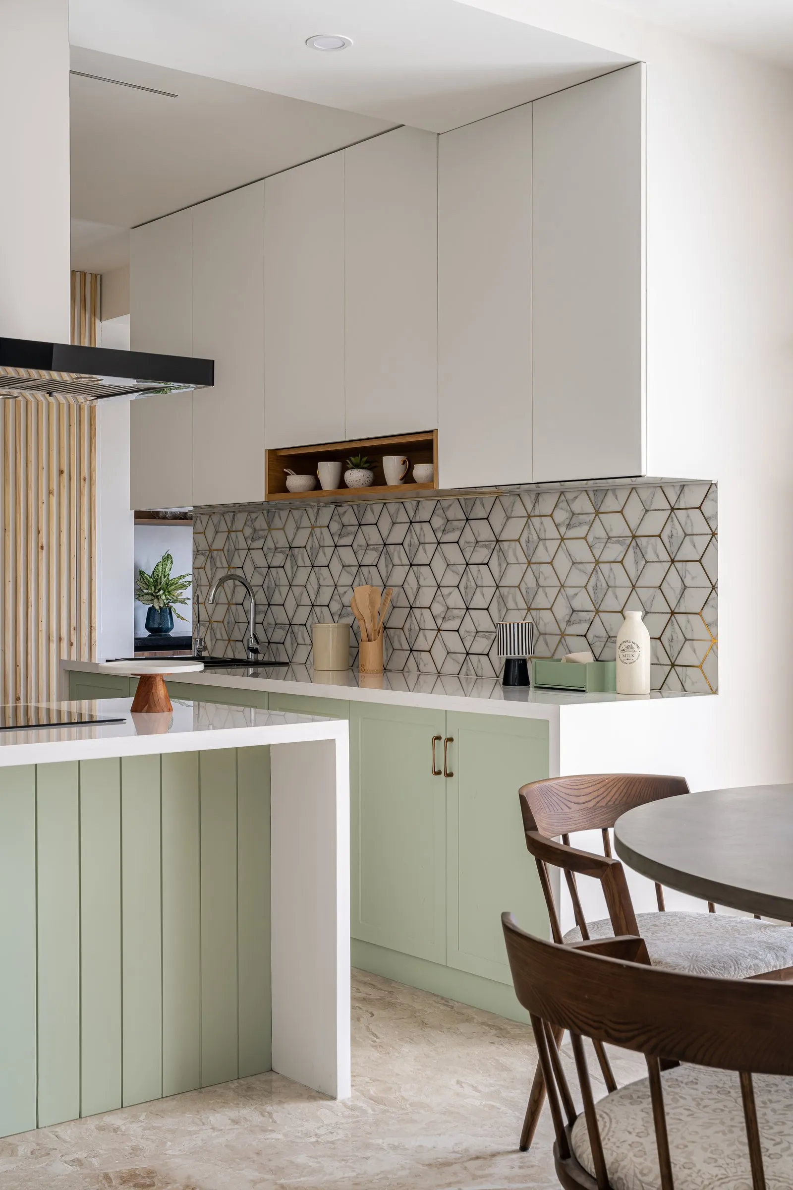 Sage kitchen island with fluted panels and patterned tiles