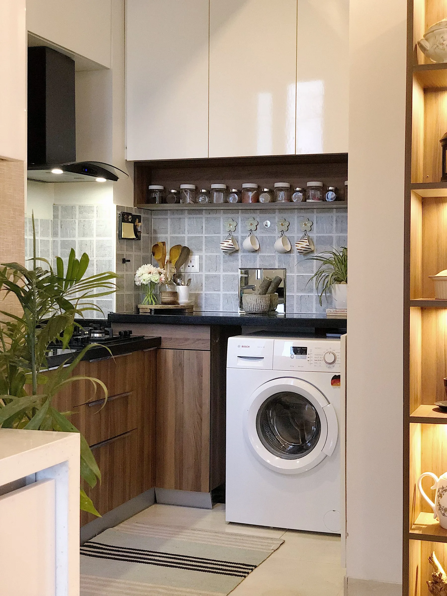 Utility corner with a washing machine and hanging cups