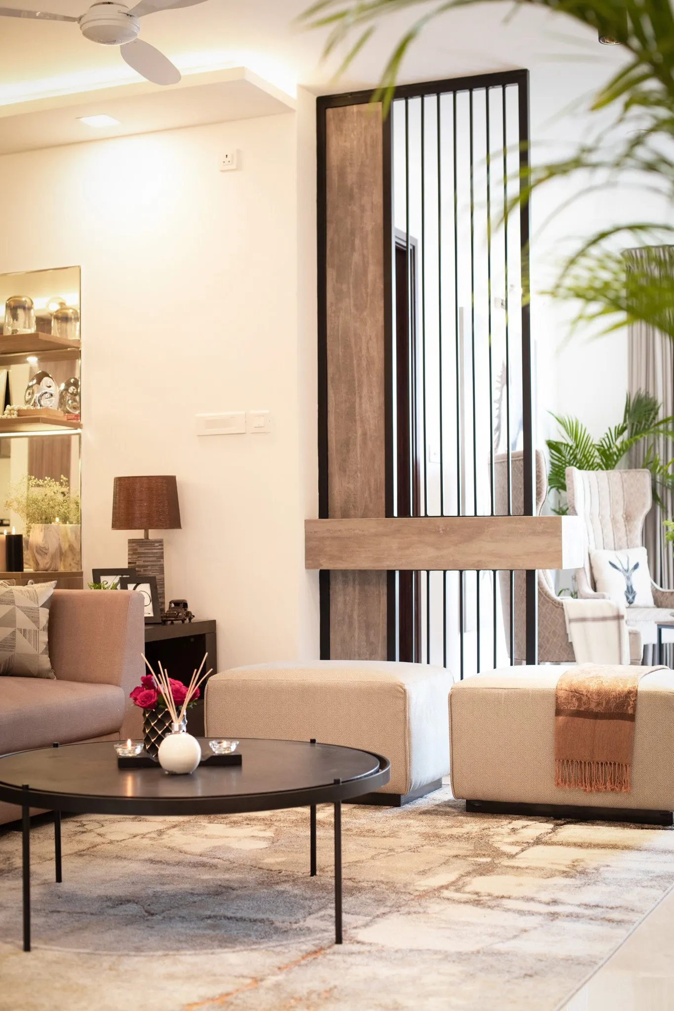 Living room with a slatted wooden screen and cream seating