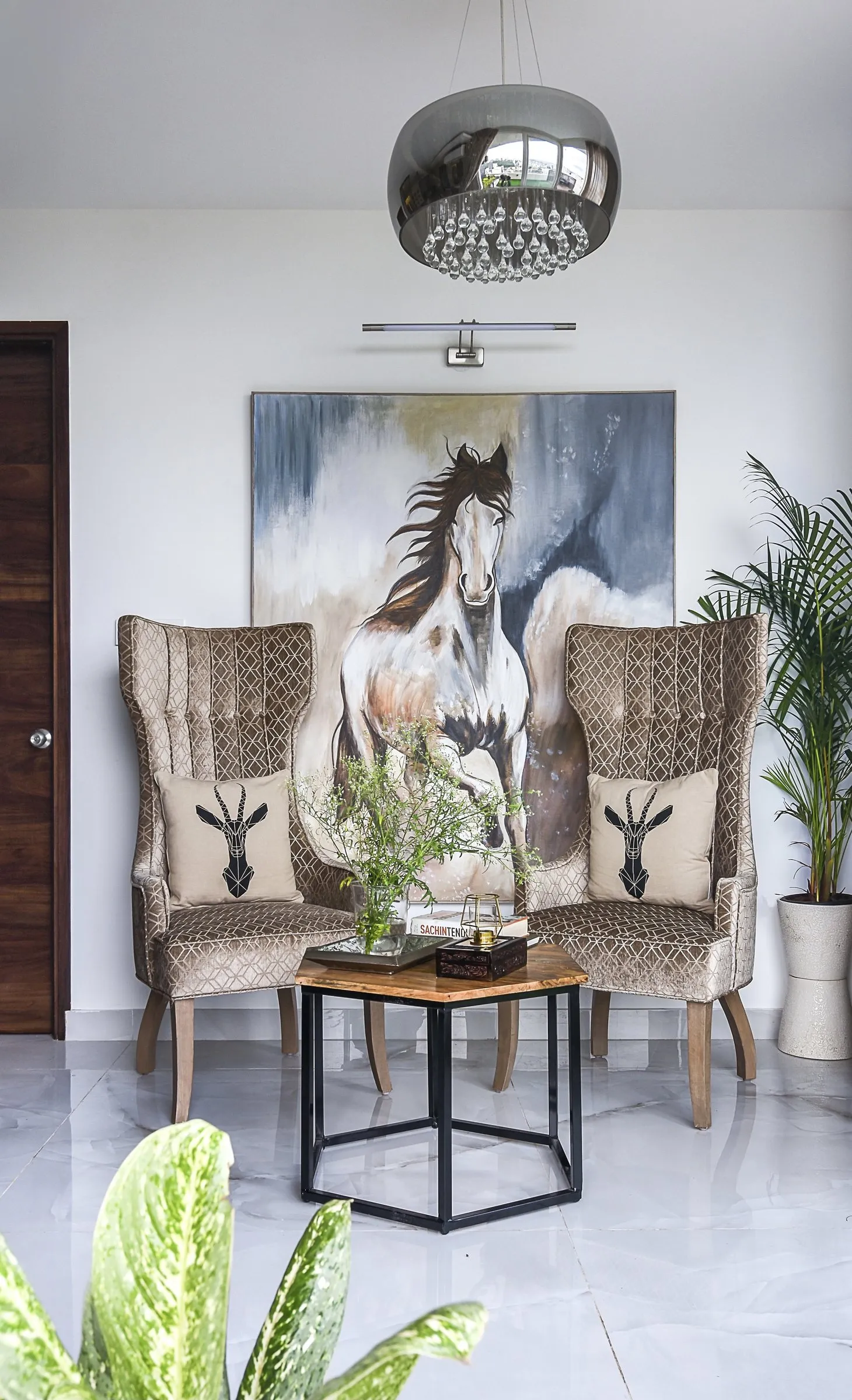 Pair of wingback chairs beneath a horse painting
