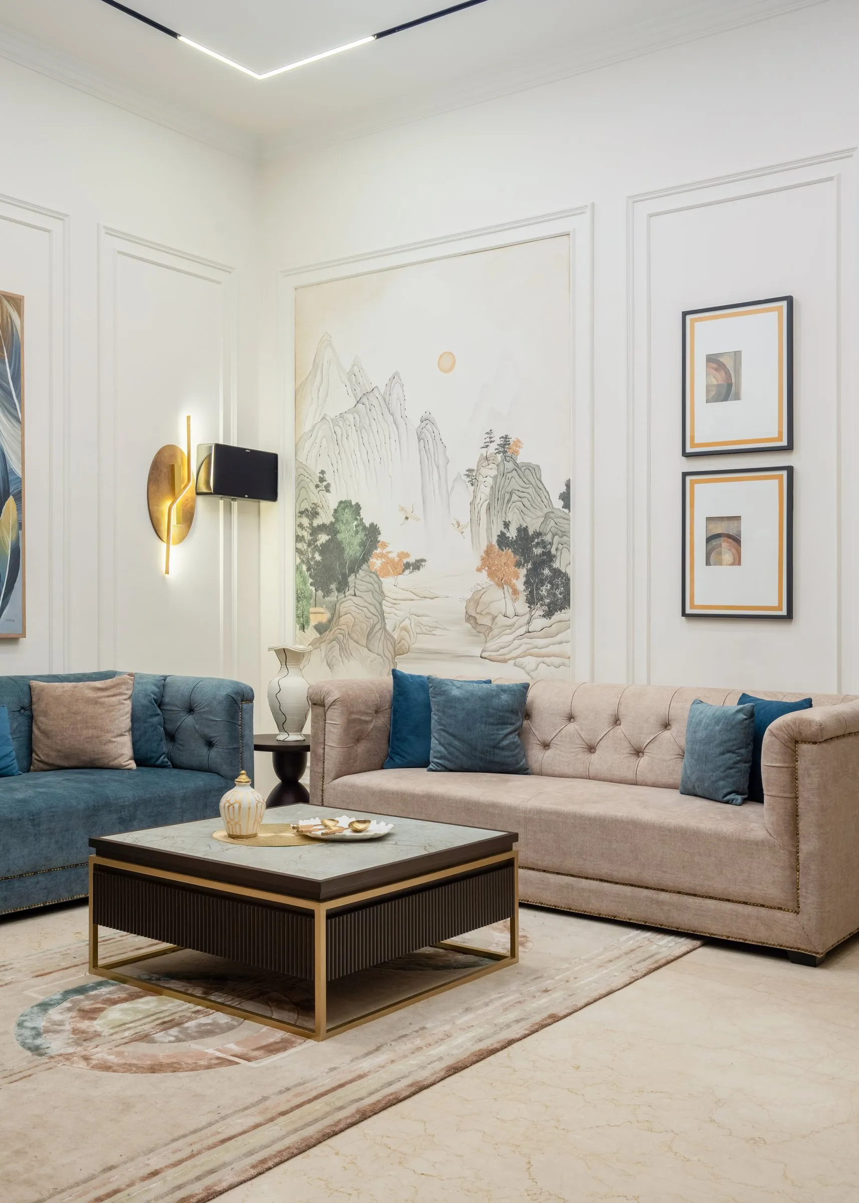 Family lounge with blue and cream sofas and a painted mural