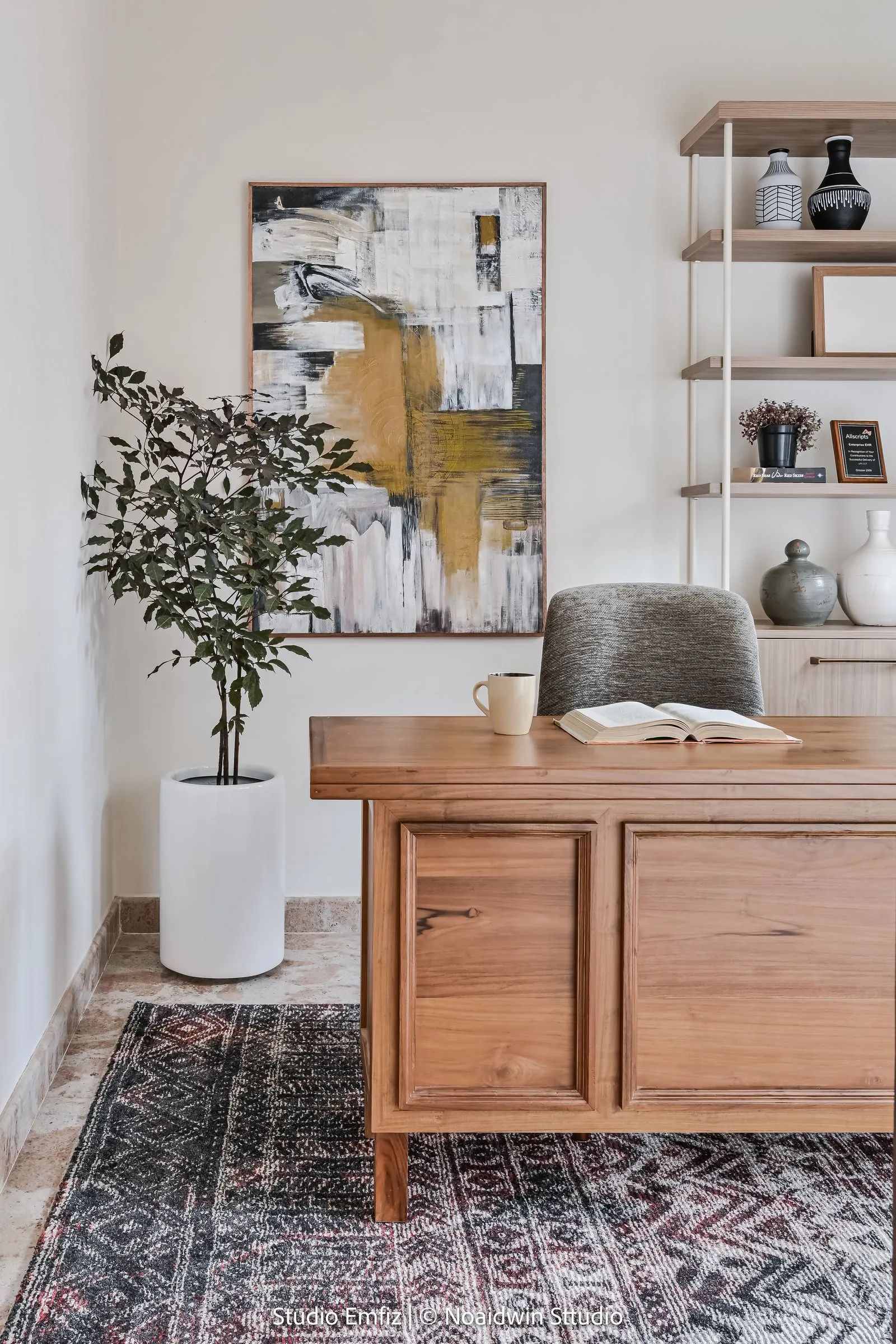 Oak study desk on a patterned rug with open shelves