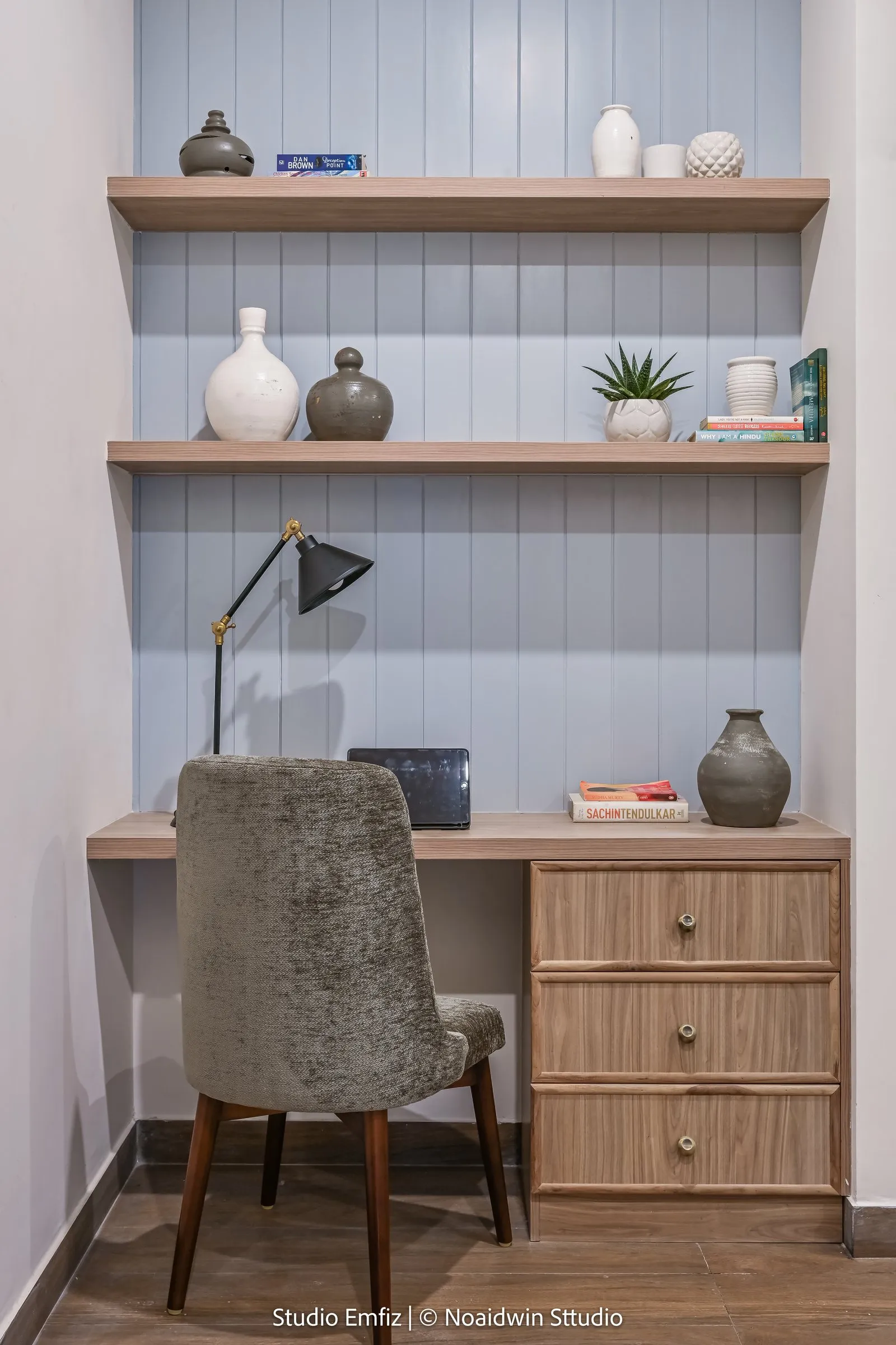 Study nook with blue panelling and oak shelves