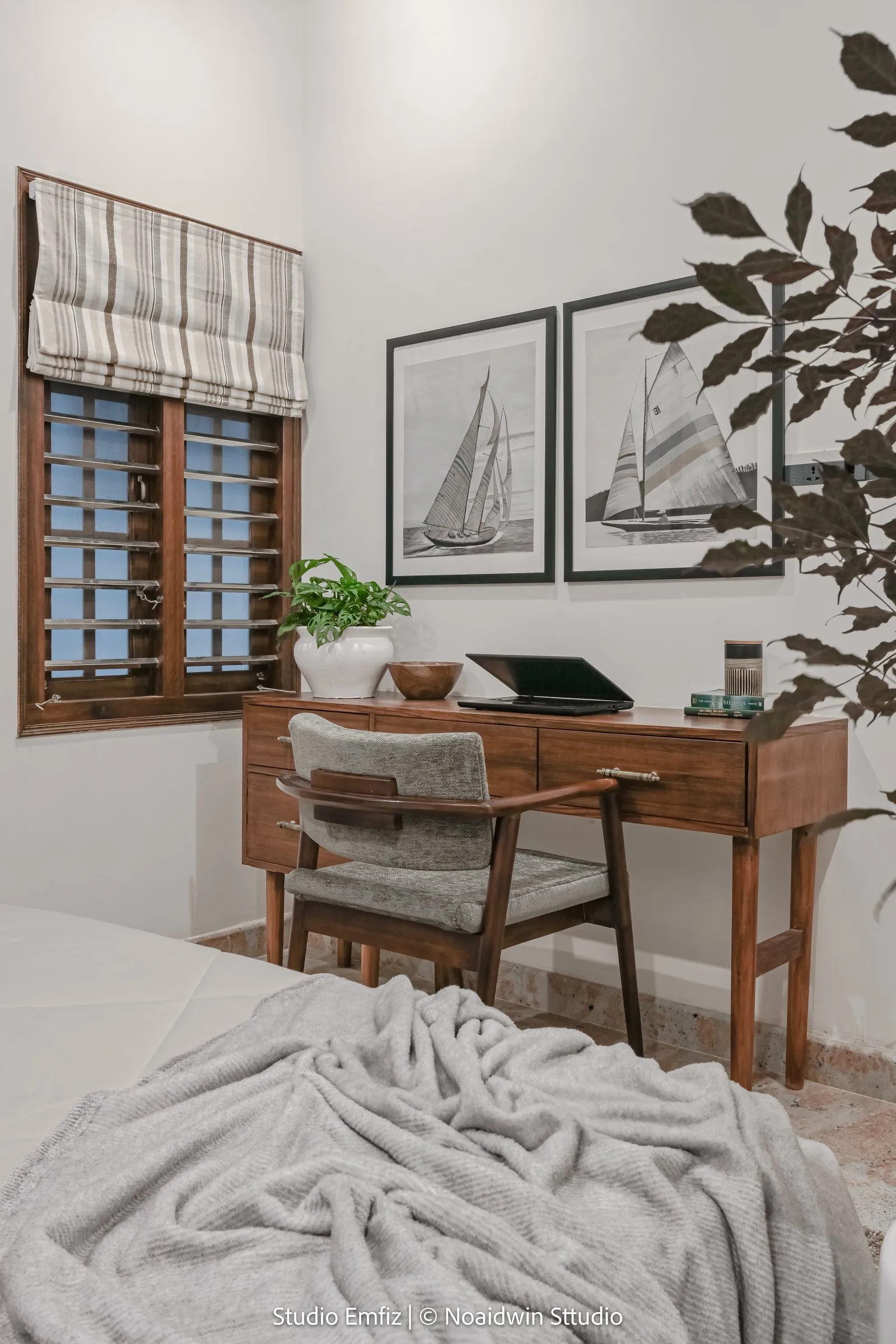 Wooden writing desk with sailing prints above